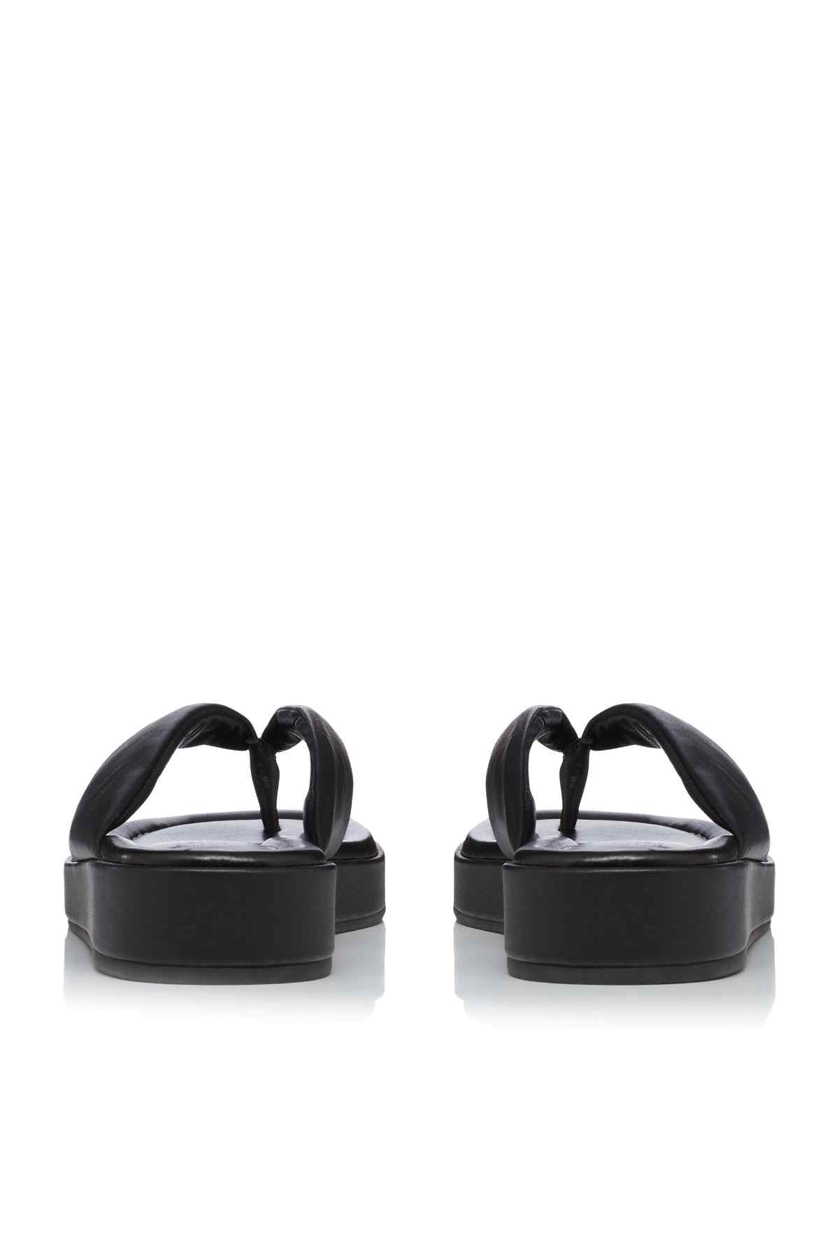 Black slide sandals back view, thong straps and thick platform heel