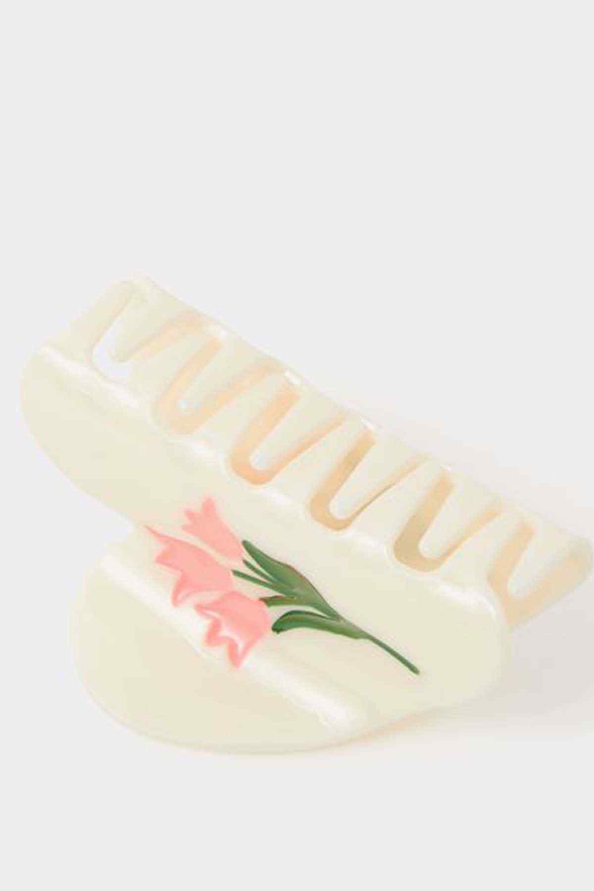 Cream slide sandals with pink floral applique and raised striped lettering