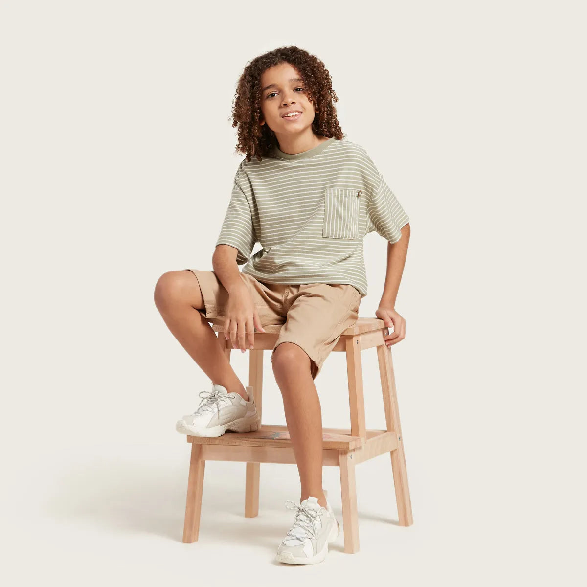 Kids green striped T-shirt with chest pocket, paired with tan shorts