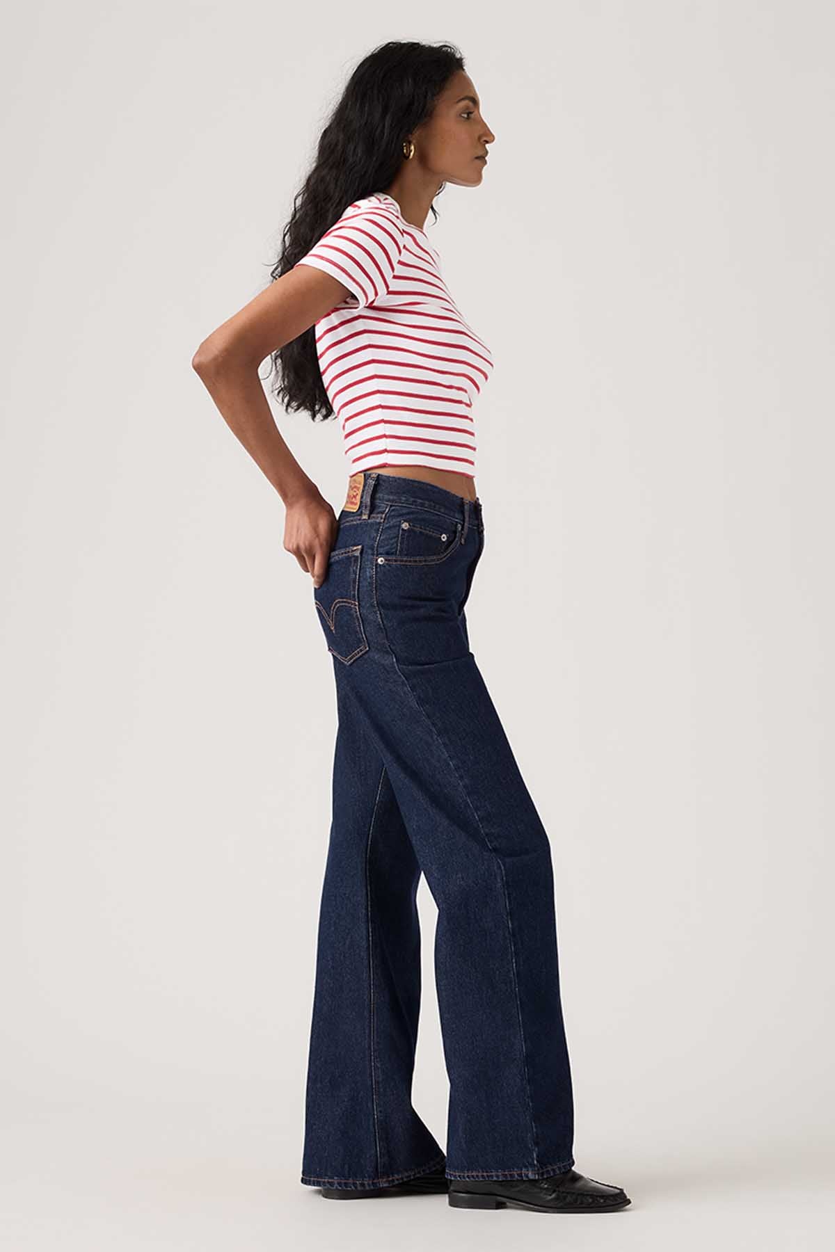 Dark indigo wide-leg jeans, side view with front pockets and belt loops