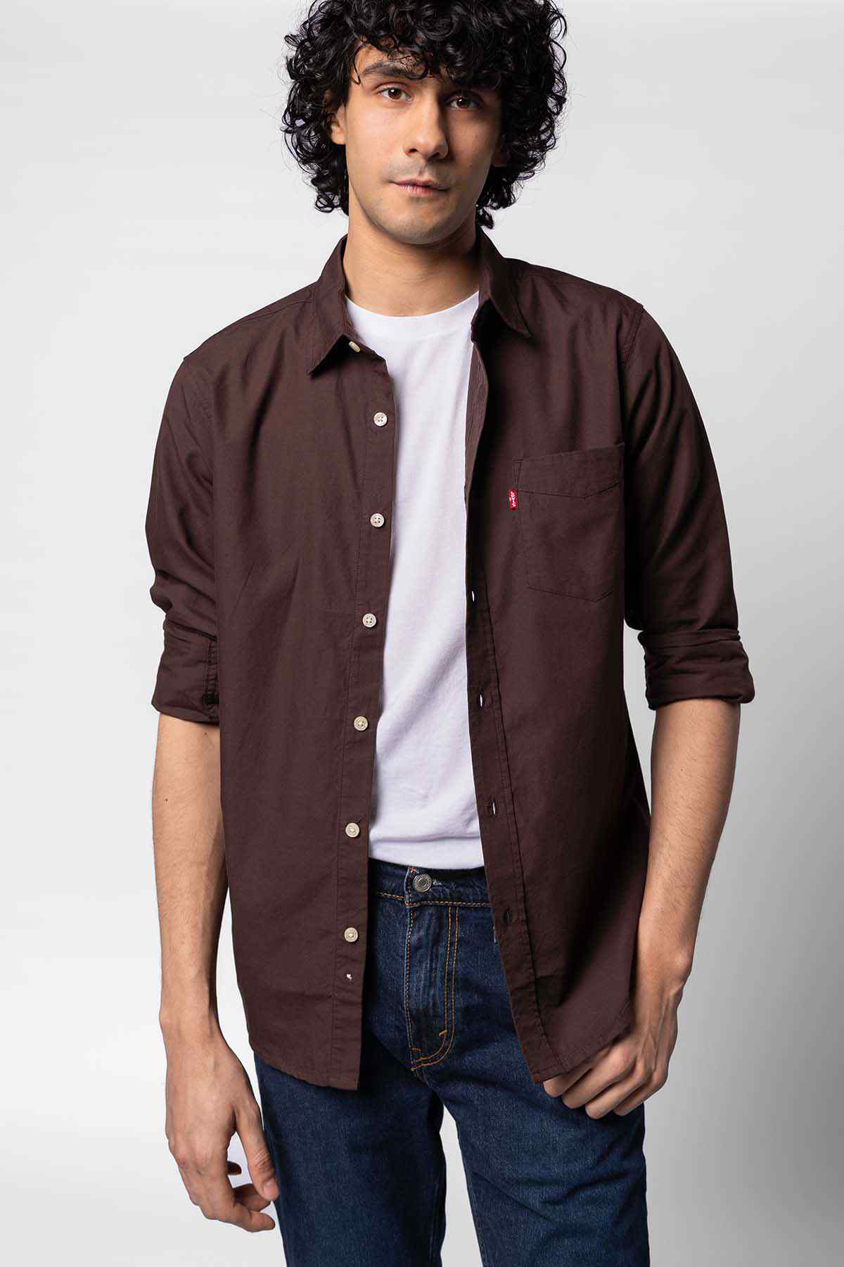 Levi's dark brown long-sleeve button-up shirt worn over a white tee