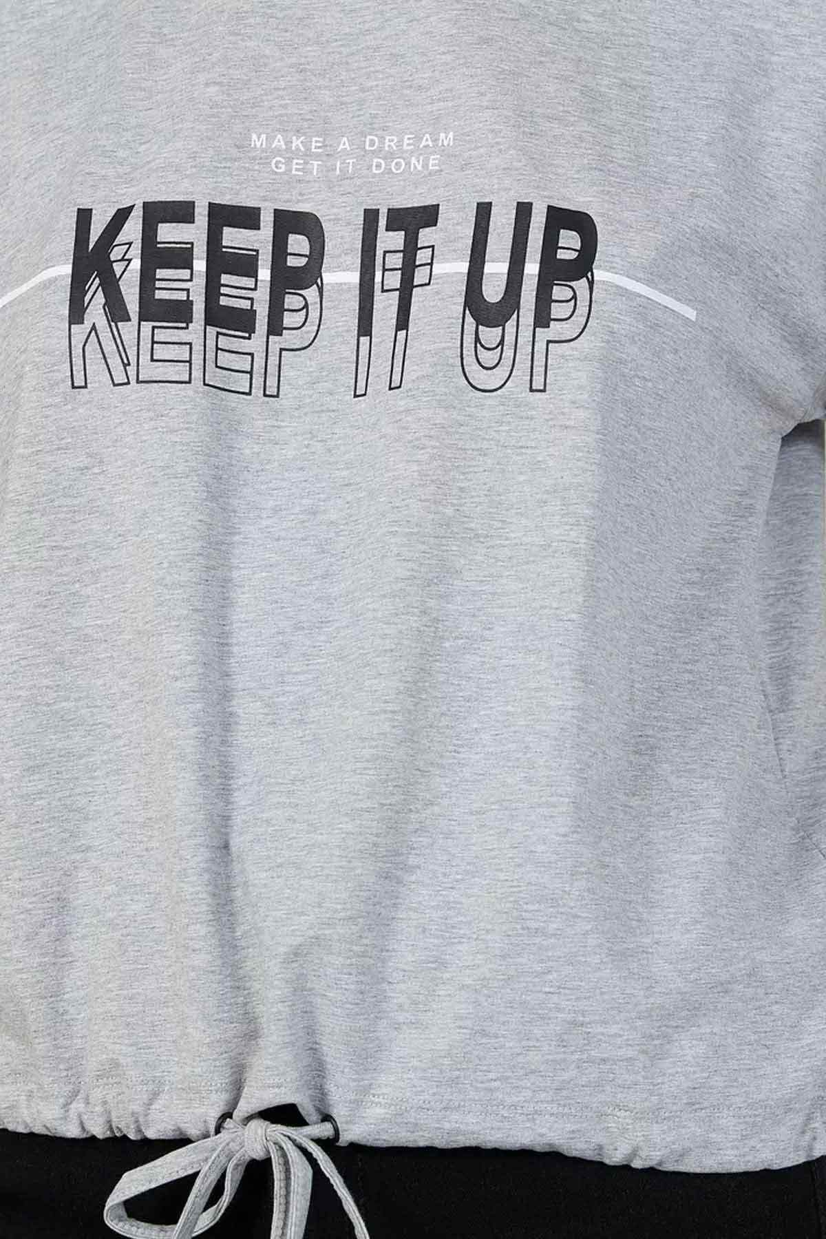 Grey T-shirt with 'KEEP IT UP' graphic and drawstring tied hem