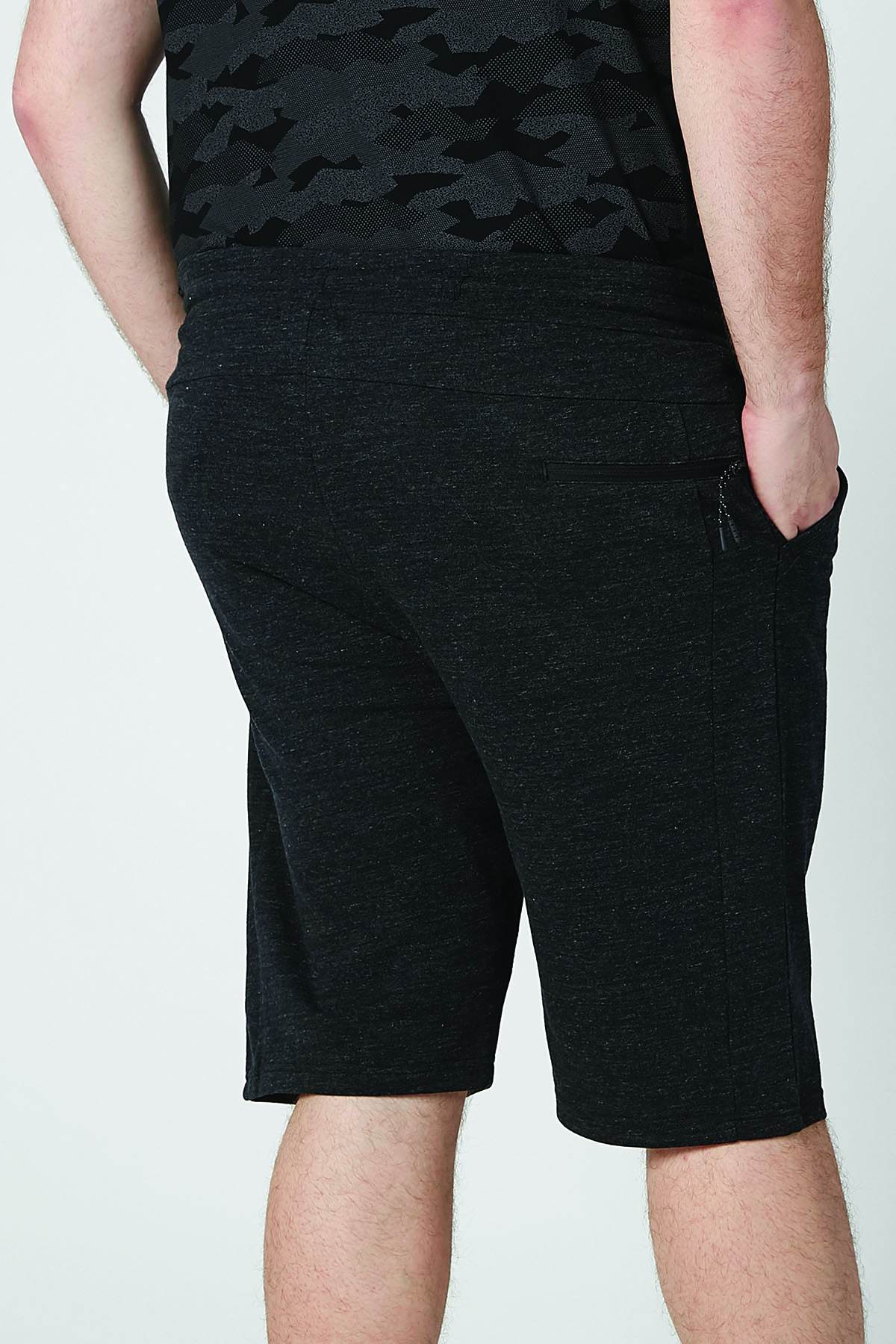 Black heather knit shorts close-up with drawstring and stitched seams