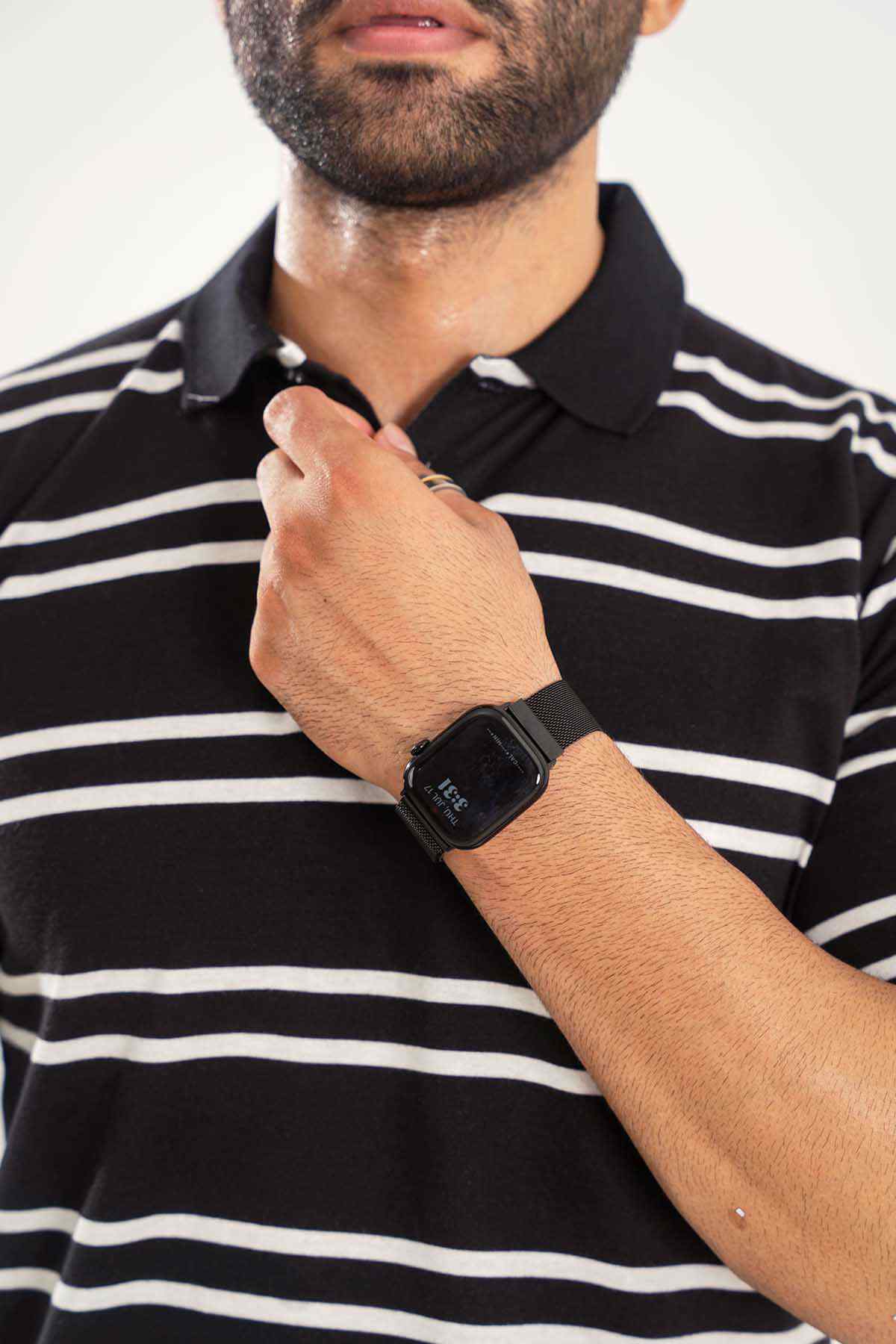 Black striped polo shirt collar close-up with hand adjusting