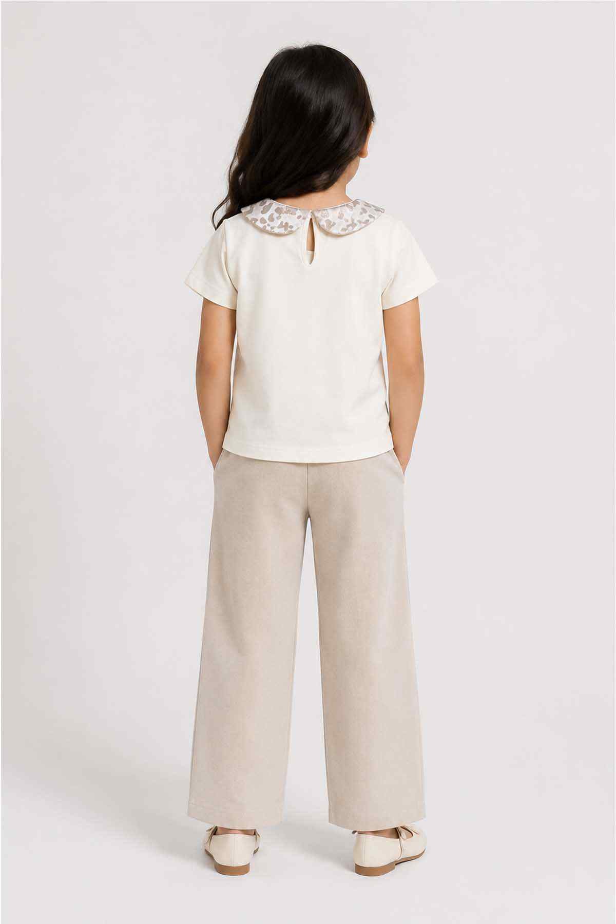 Back view of white baby top with lace-trimmed Peter Pan collar and keyhole