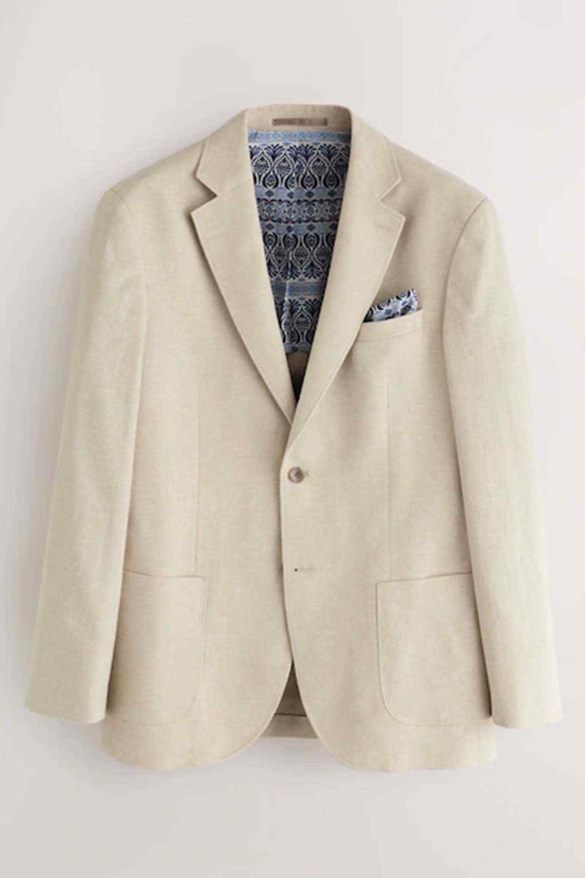 Stone blazer with notch lapels, pocket square, and patterned lining