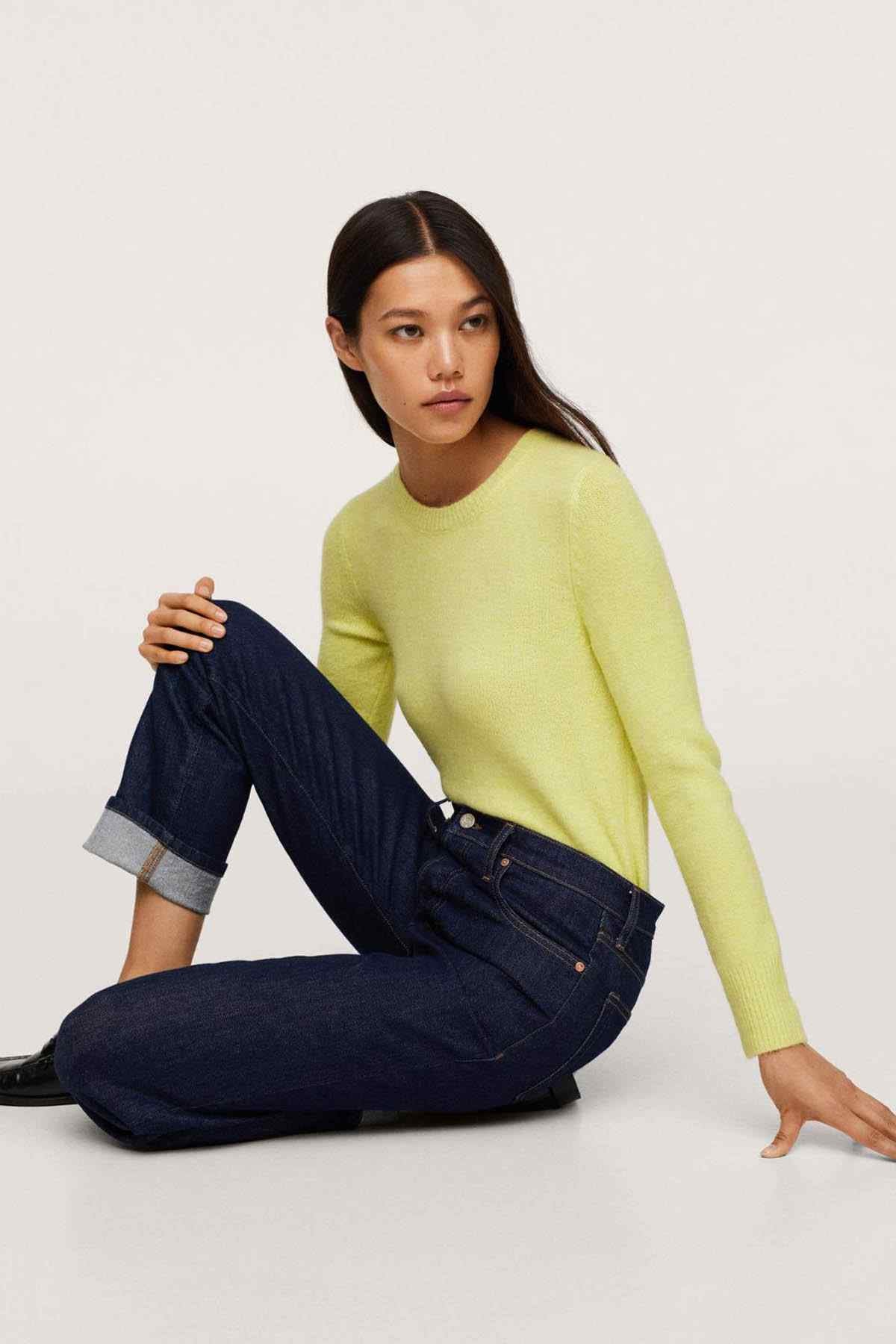 Lime green crew-neck sweater with long sleeves, worn with dark jeans