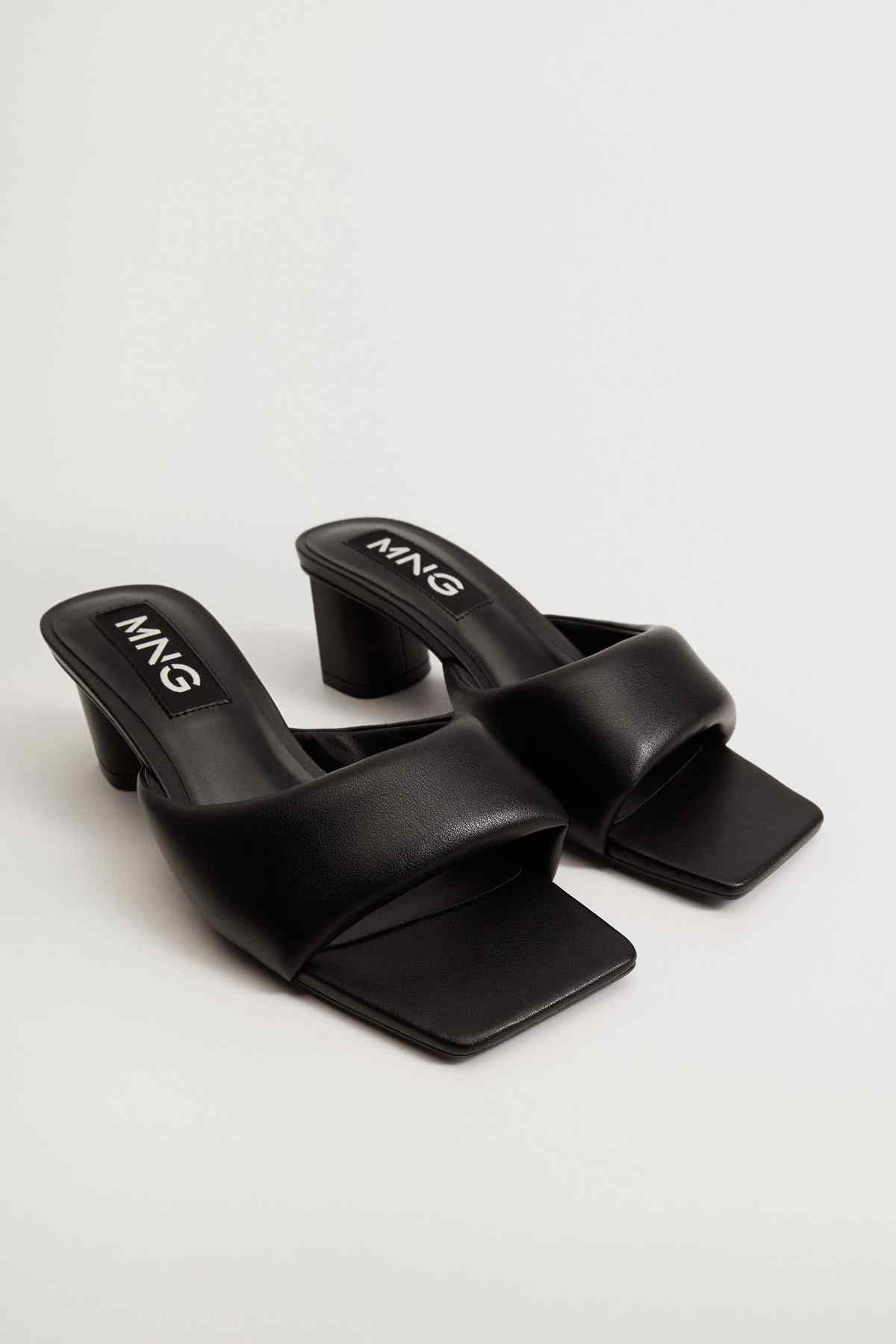 Black heeled mules with wide straps, squared open toe, and 'MANGO' logo footbed.