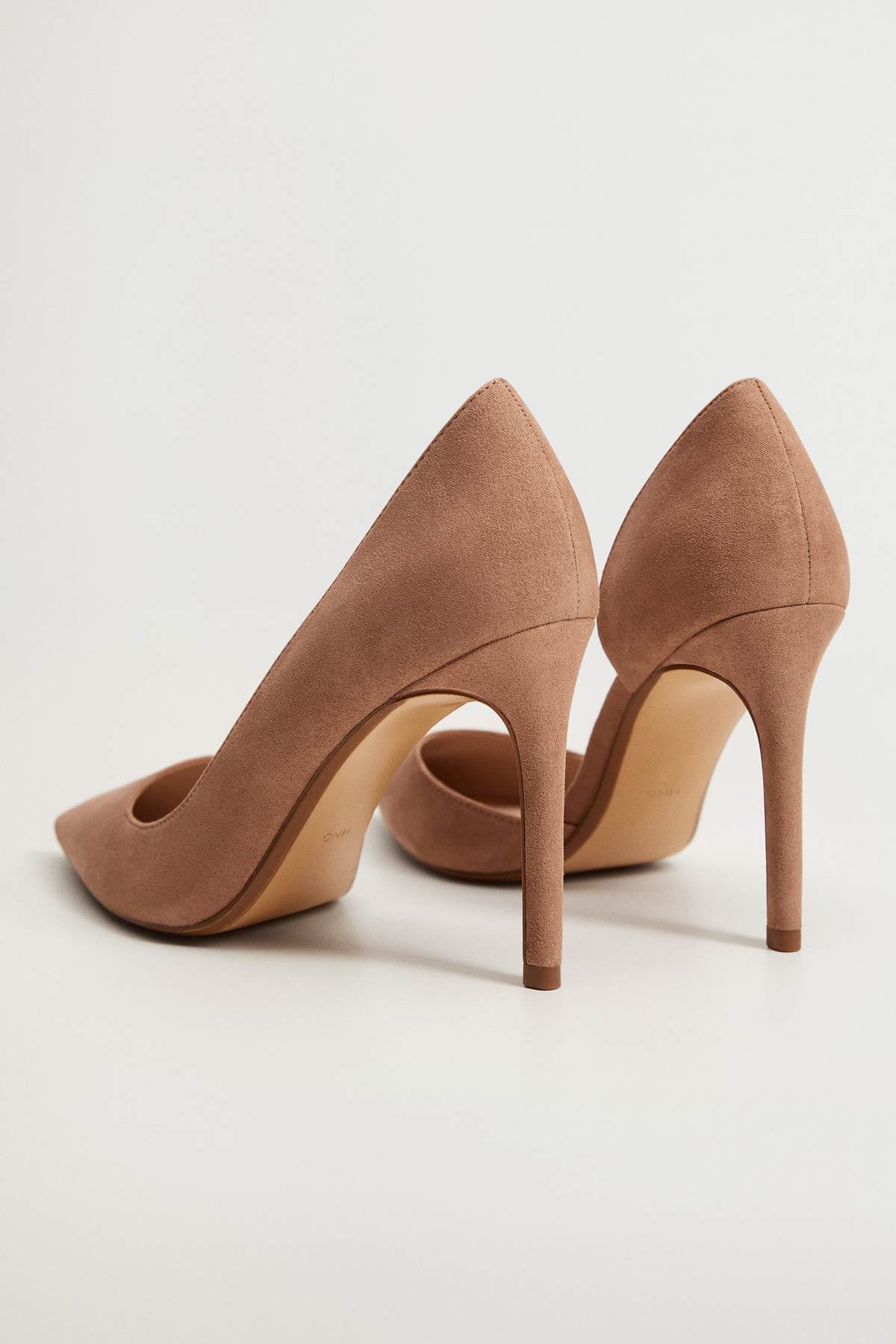 Tan pointed-toe stiletto heel pumps, angled view of heels and toe