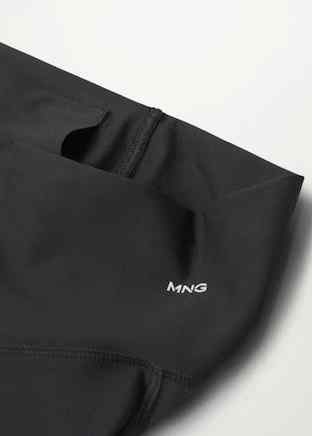 Black leggings close-up of waistband, inner label, and logo