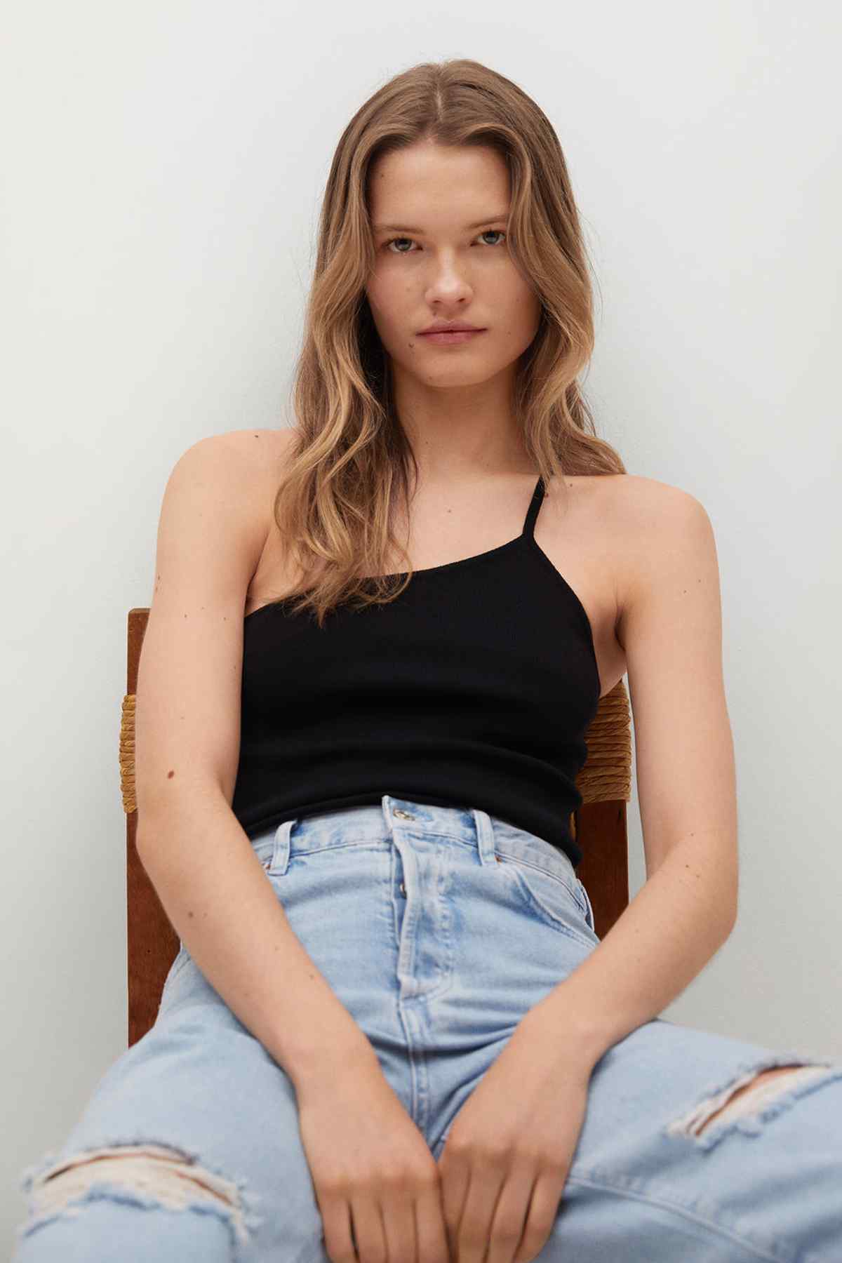 Black camisole top with thin straps and fitted bodice