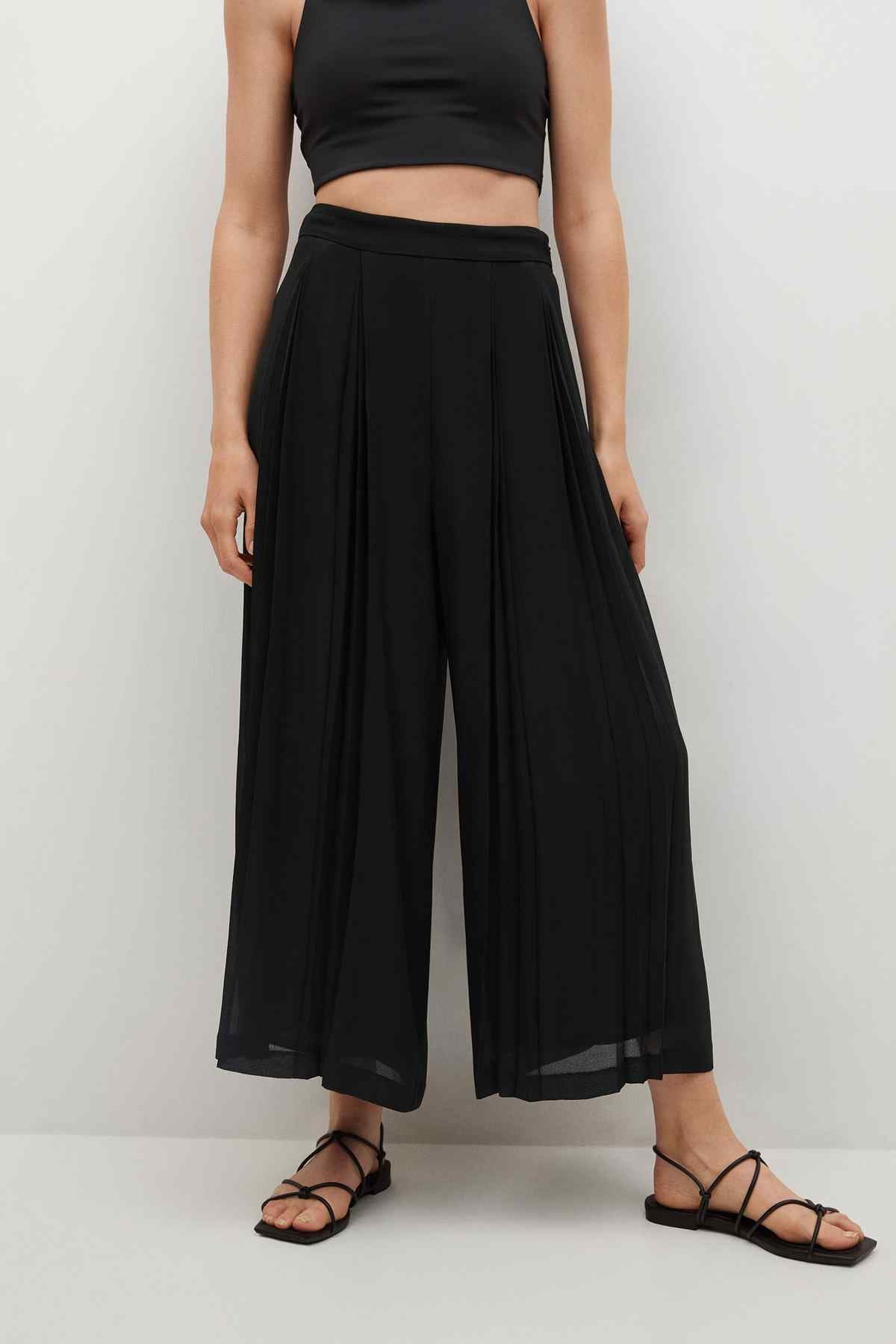 Black wide-leg high-waist pants with pleated drape, paired with cropped top