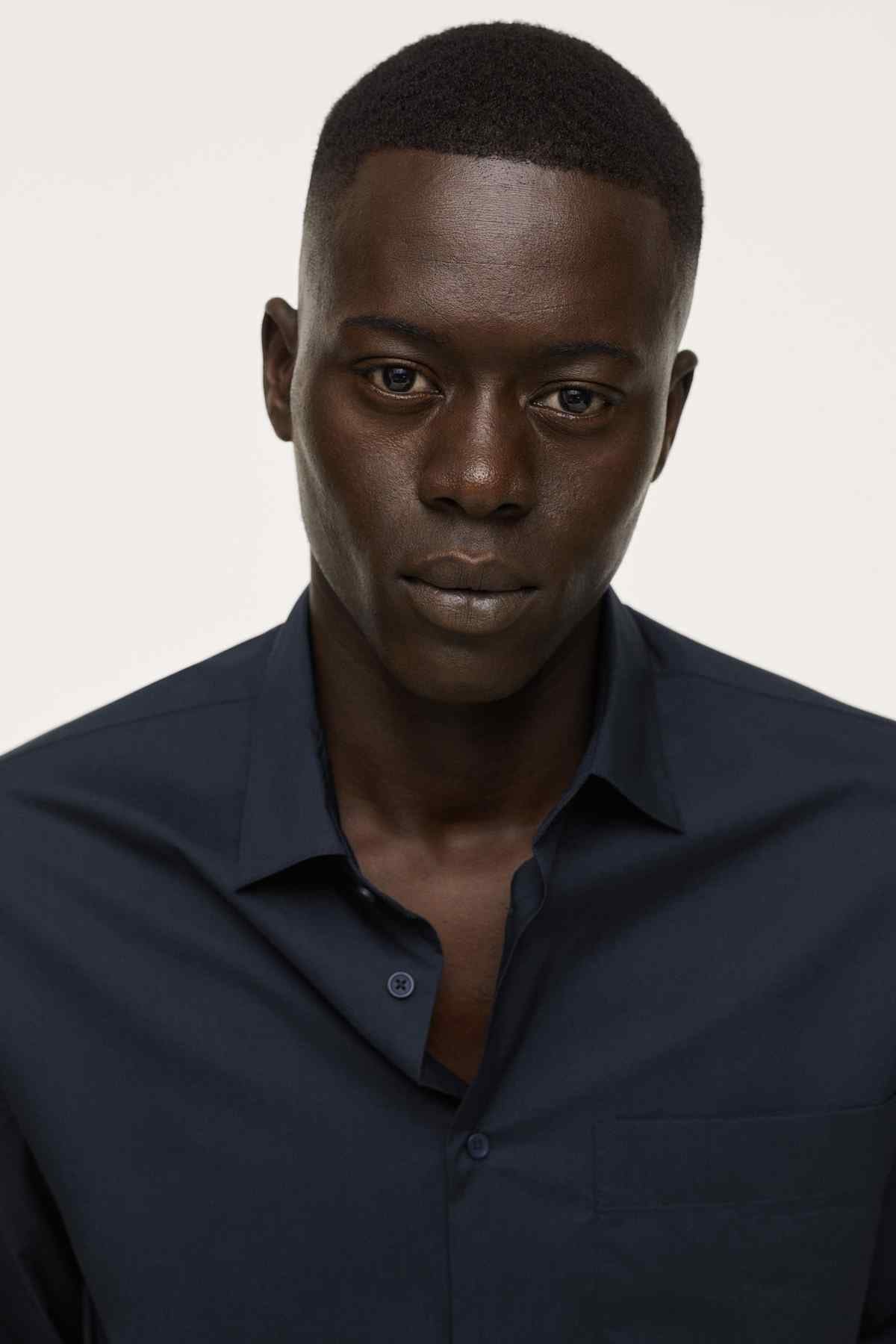 Navy button-up shirt close-up with collar and chest pocket