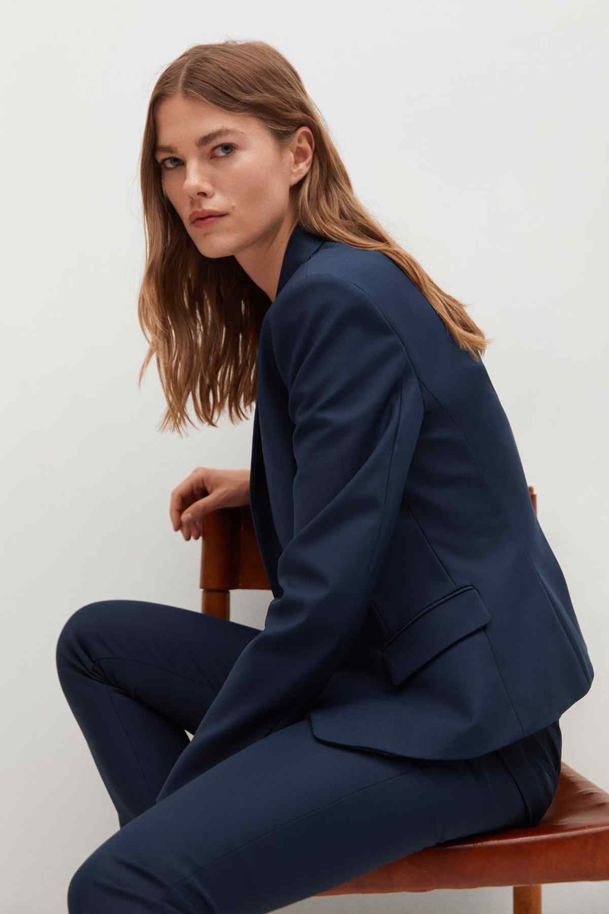 Dark navy blazer and slim-fit trousers, side angle with cuff details