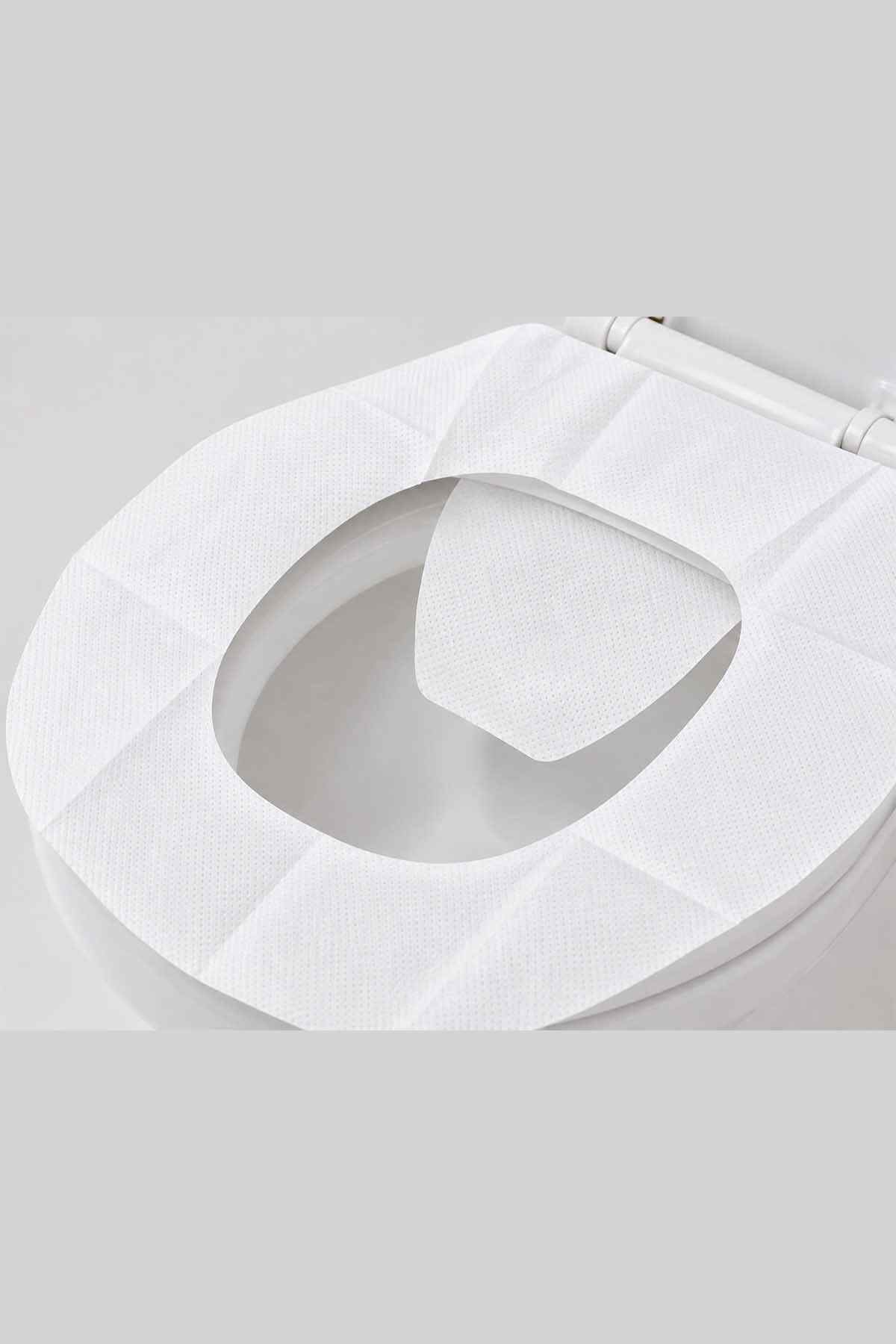 White disposable toilet seat cover with oval opening, curved seat-shaped pad