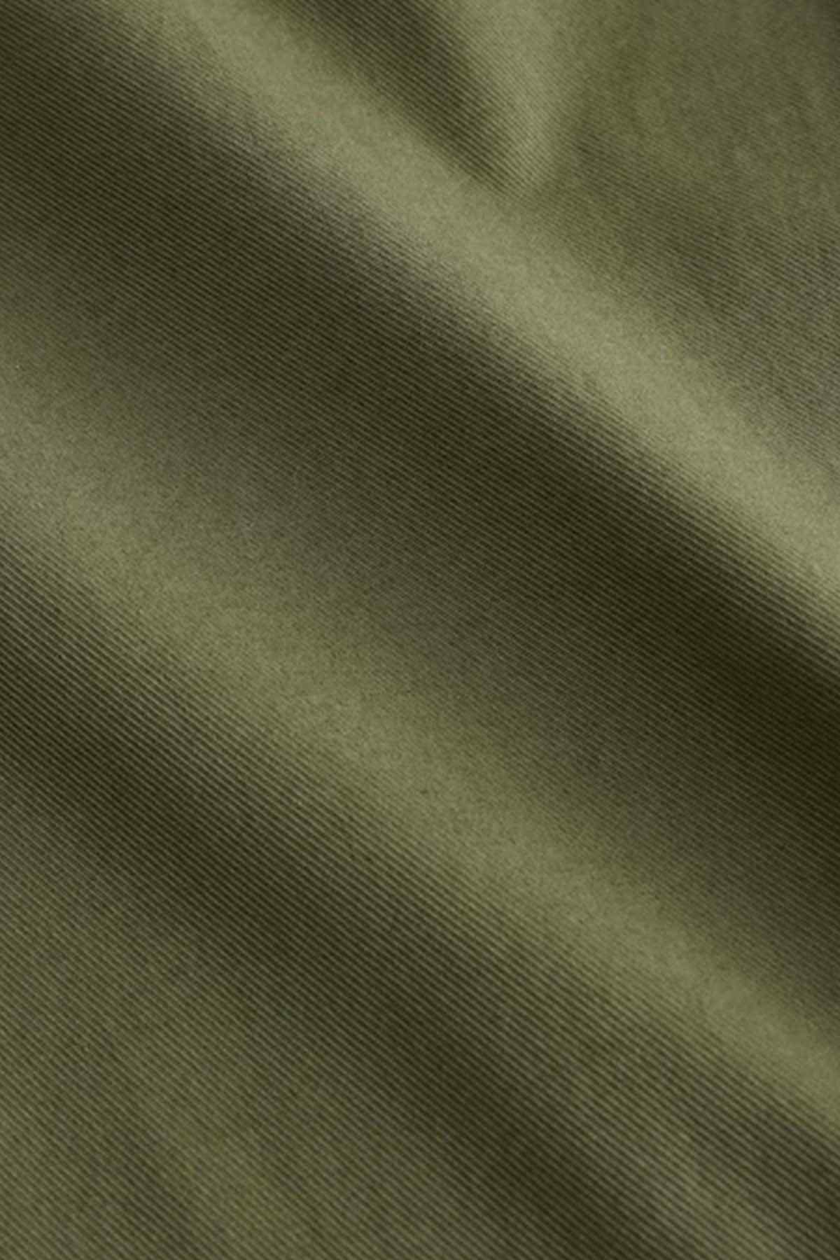 Olive green woven fabric close-up with fine textured pattern