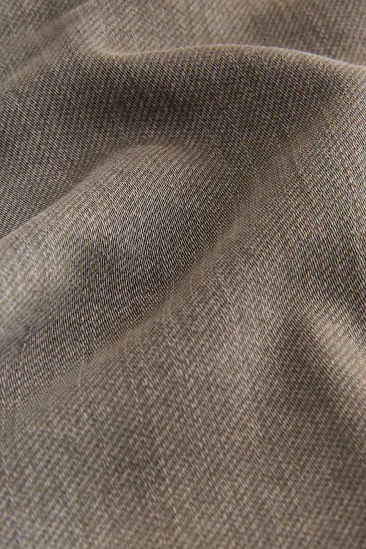 Brown denim fabric close-up with fine twill texture