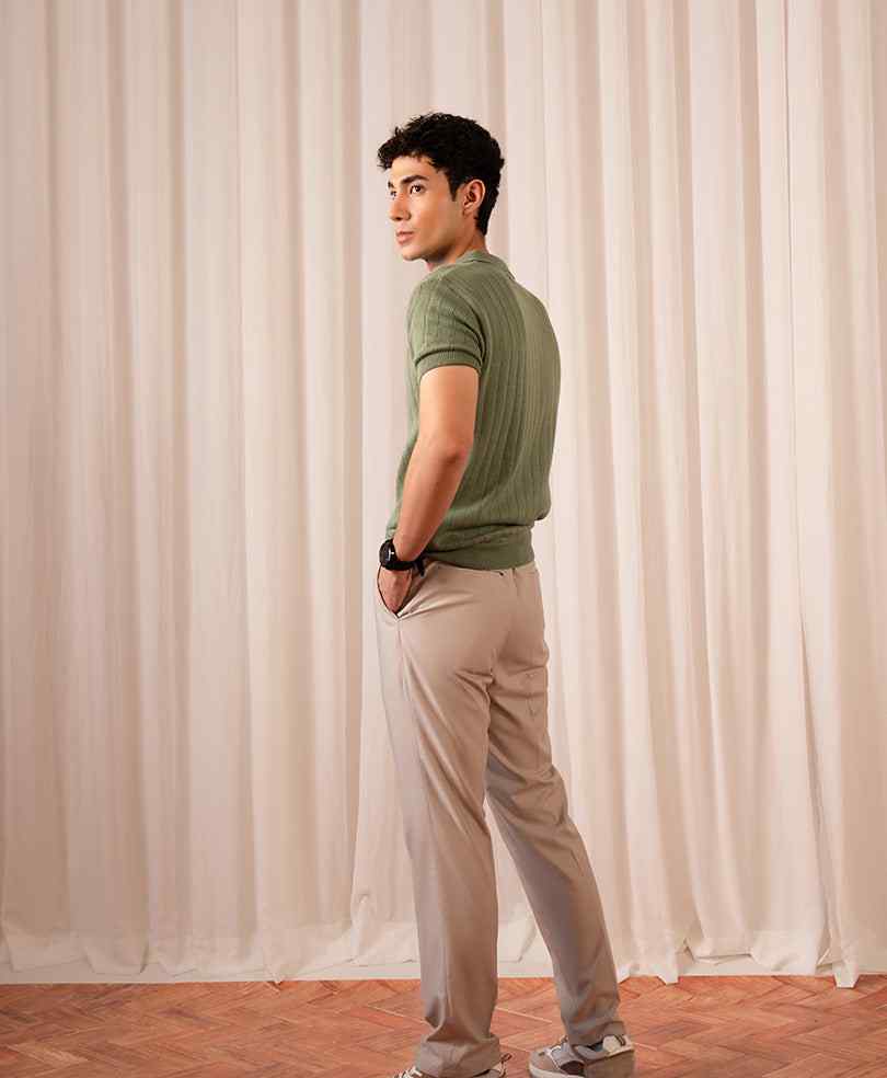Fitted olive green knit polo shirt shown from side, short sleeves and button placket