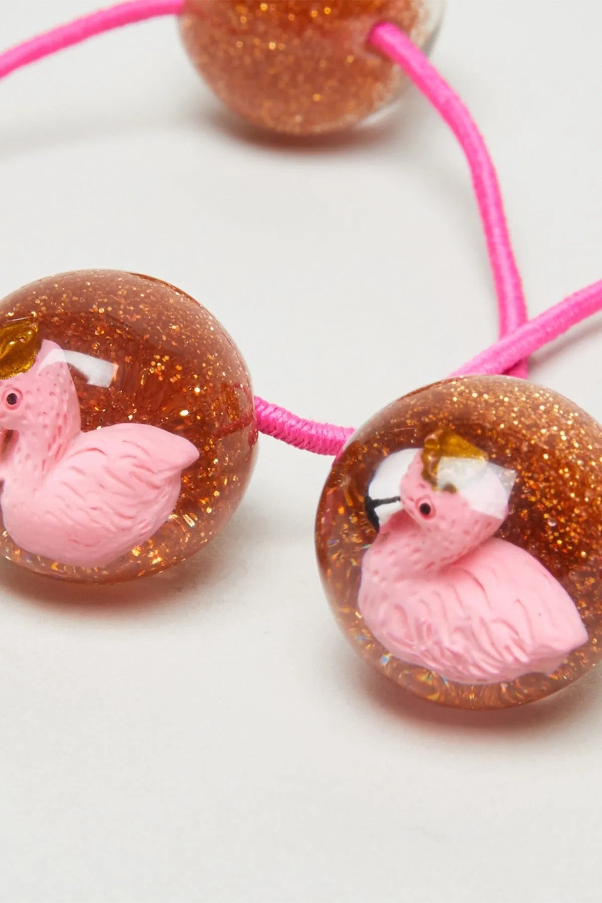 Glitter brown bead hair tie with pink pig charm and bright pink elastic band
