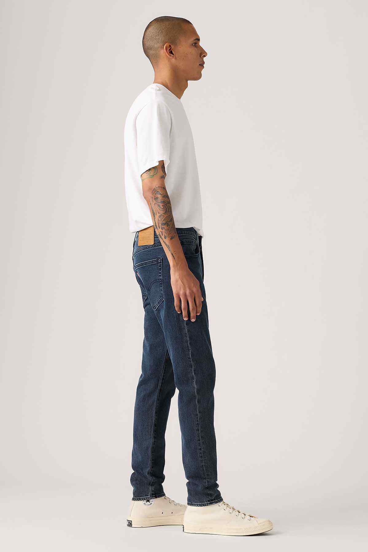 Levi's dark blue straight jeans, side view with cuffed hem