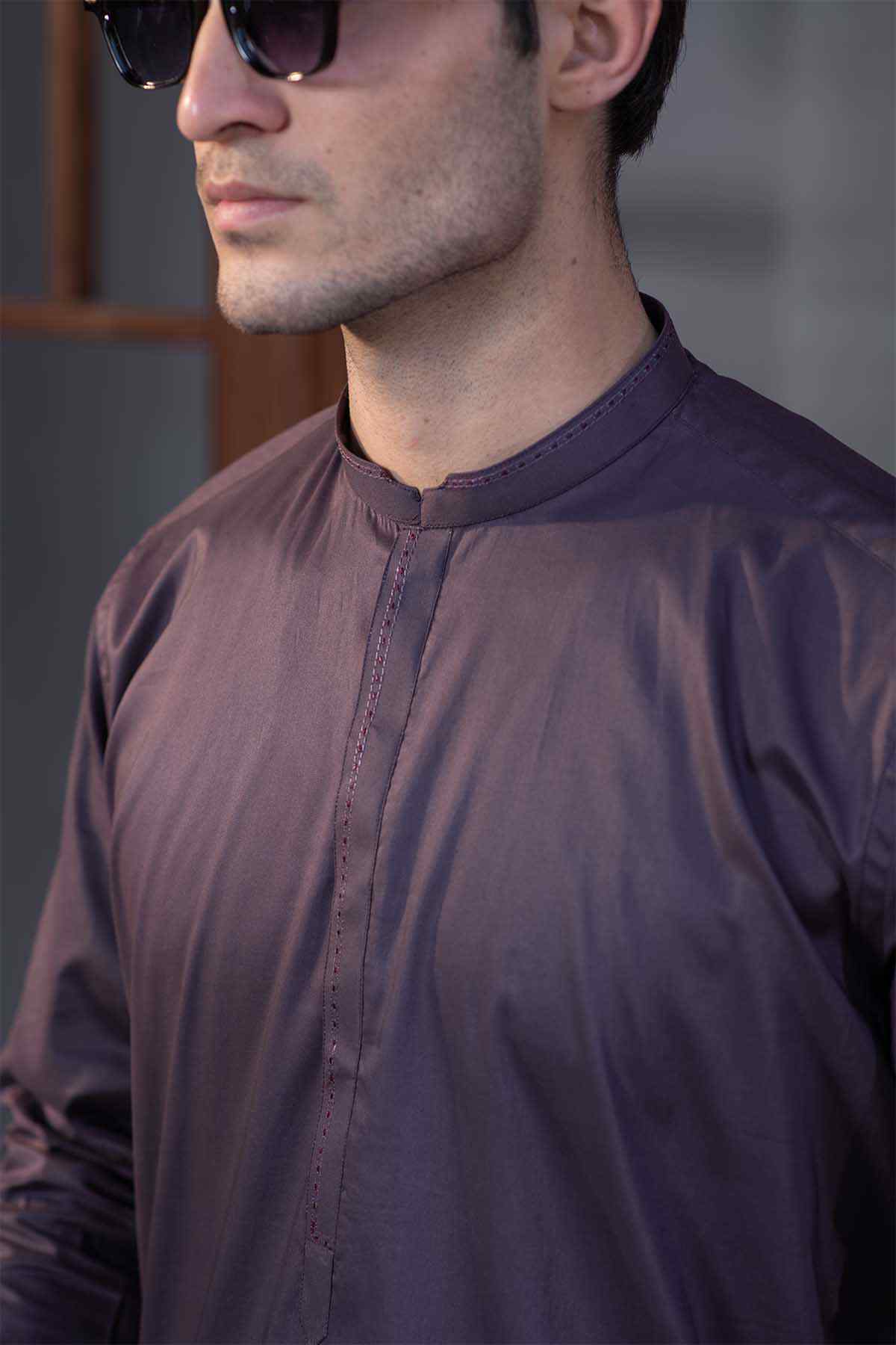 Burgundy tunic neckline close-up with stand collar and centered button placket.