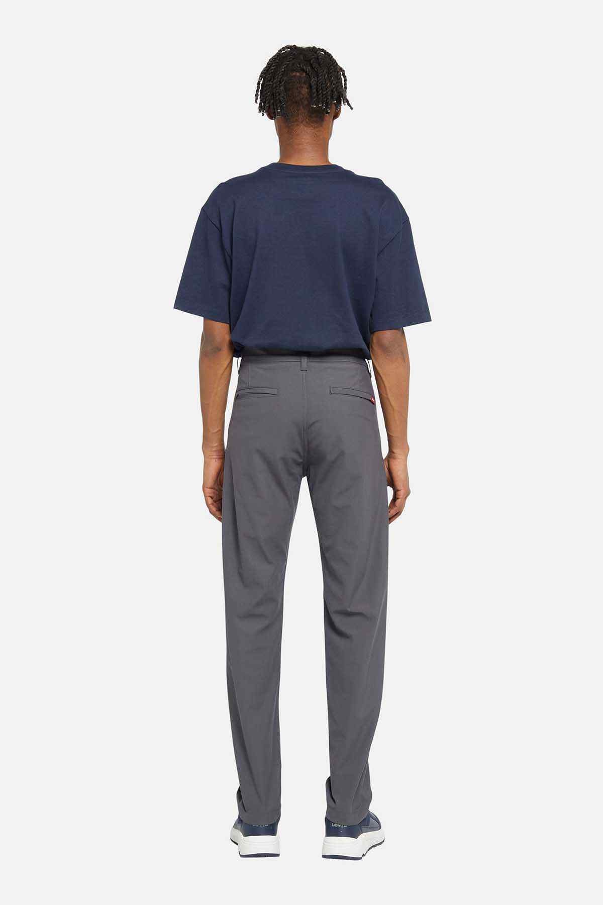 Levi's navy short-sleeve T-shirt and grey straight-leg pants, back view
