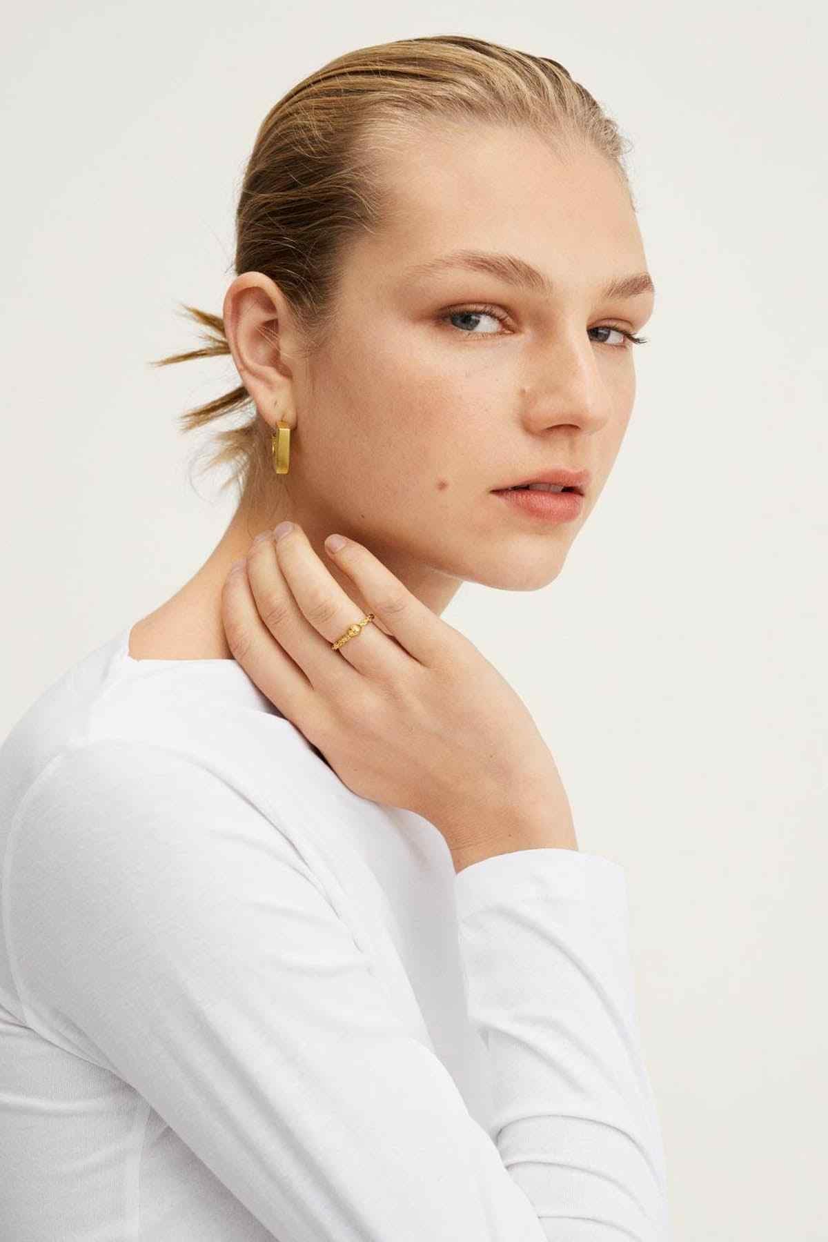 White long-sleeve top close-up, wide neckline and smooth fabric