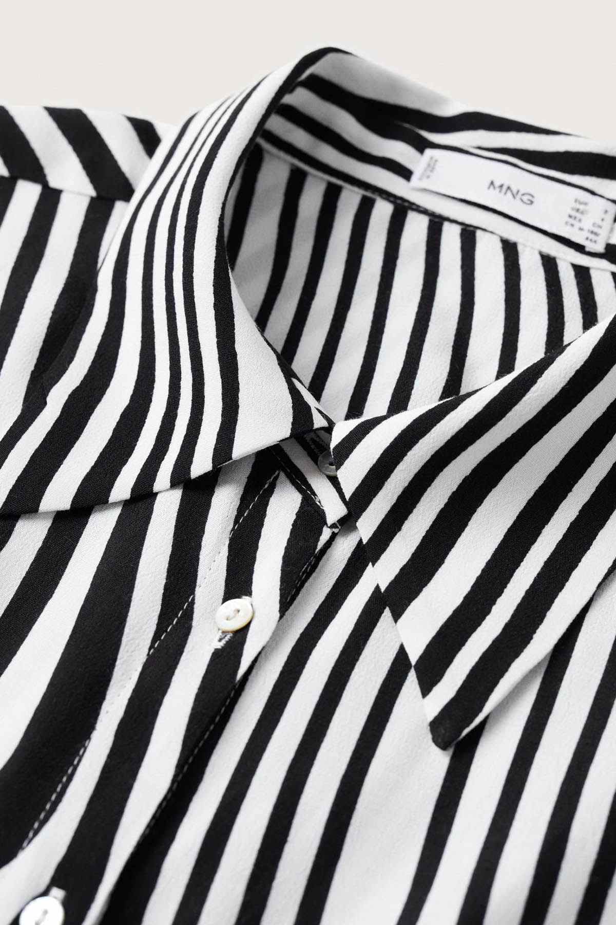 Close-up of striped shirt dress collar with button placket and fabric texture