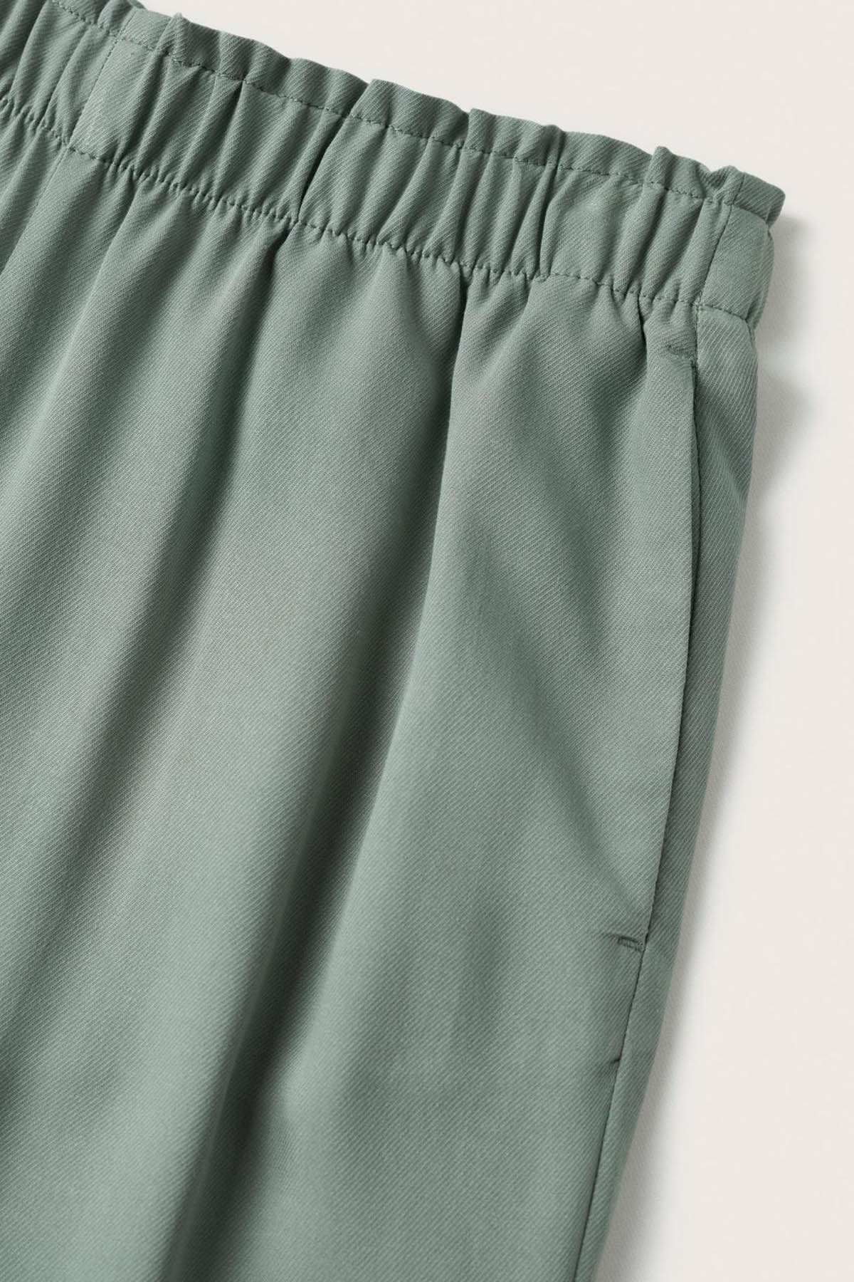 Light teal trouser fabric with gathered elastic waistband detail
