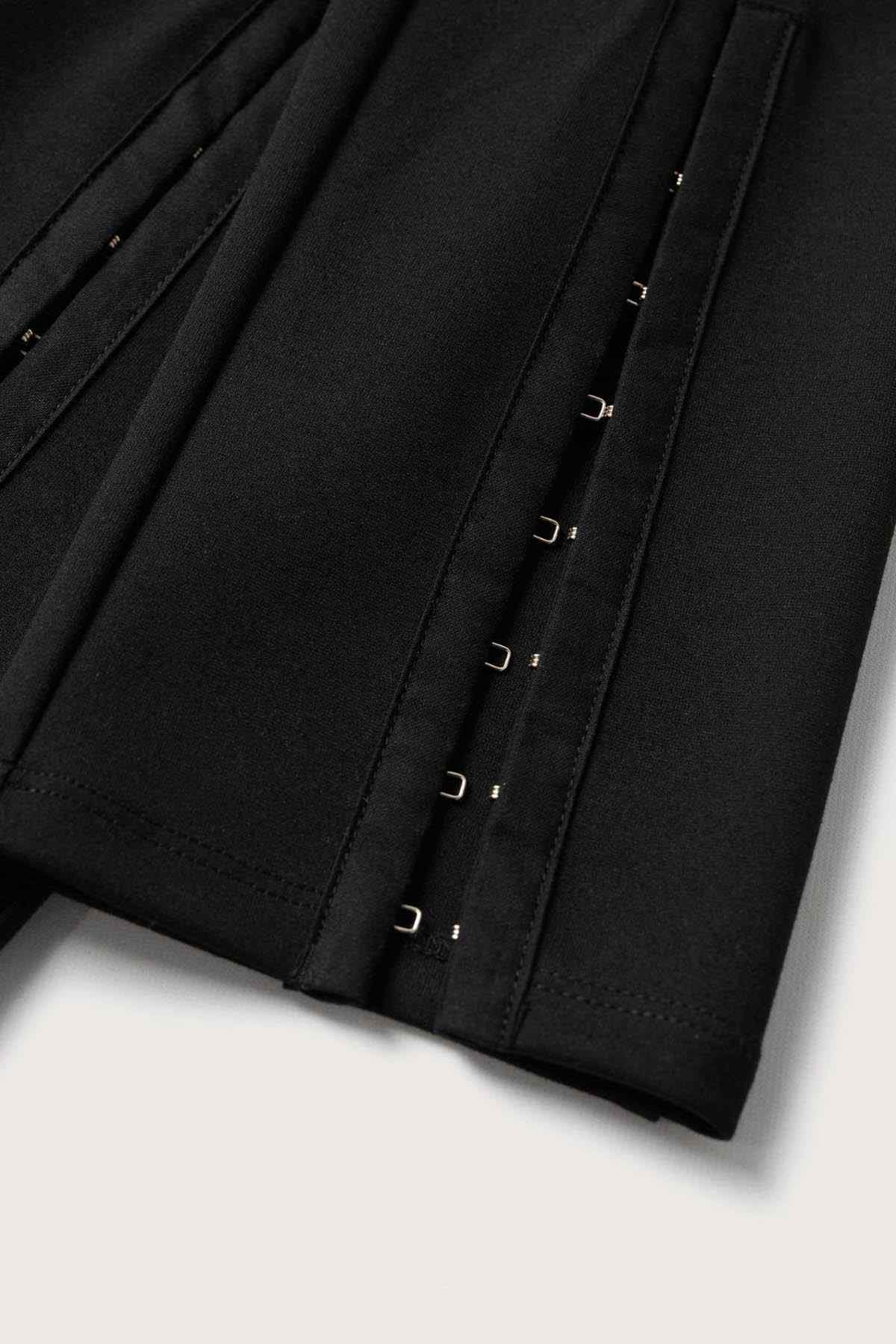 MANGO black tailored pants detail with stitched panels and metal fasteners