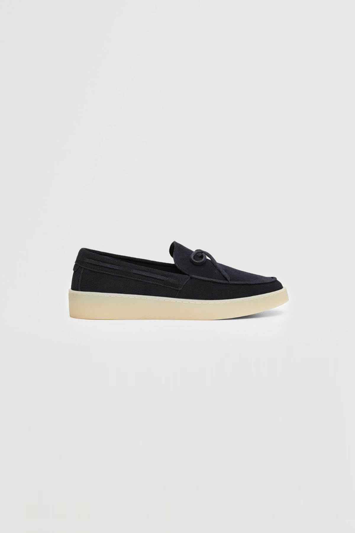 Single navy suede platform loafer with tied bow and flat off-white sole