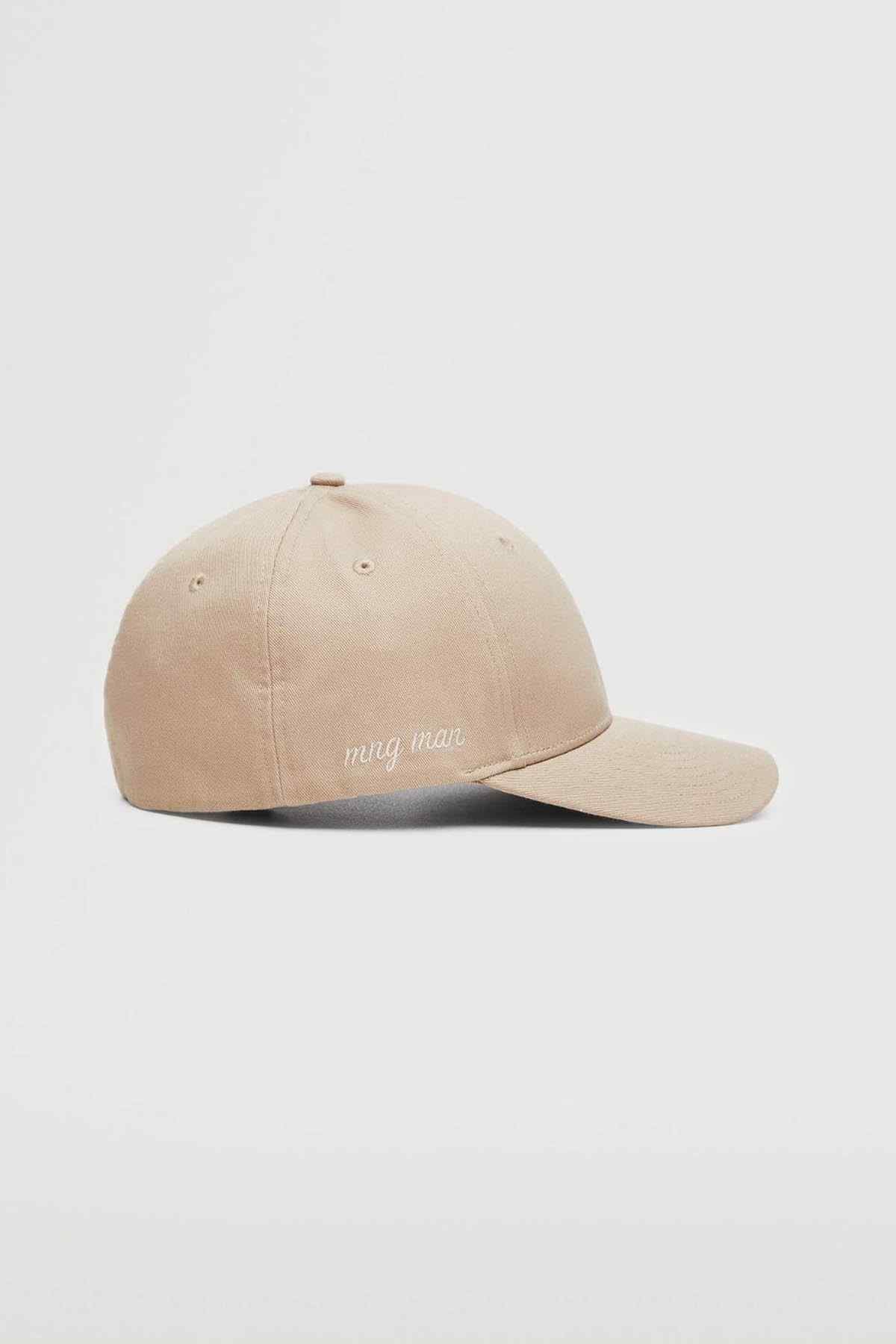 Beige baseball cap with curved brim and 'mng mng' front logo, side view