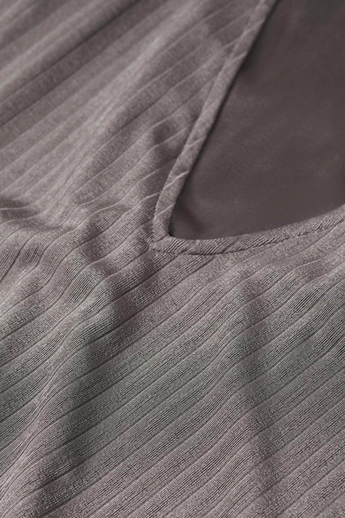 Grey ribbed knit fabric close-up with subtle texture and seam detail