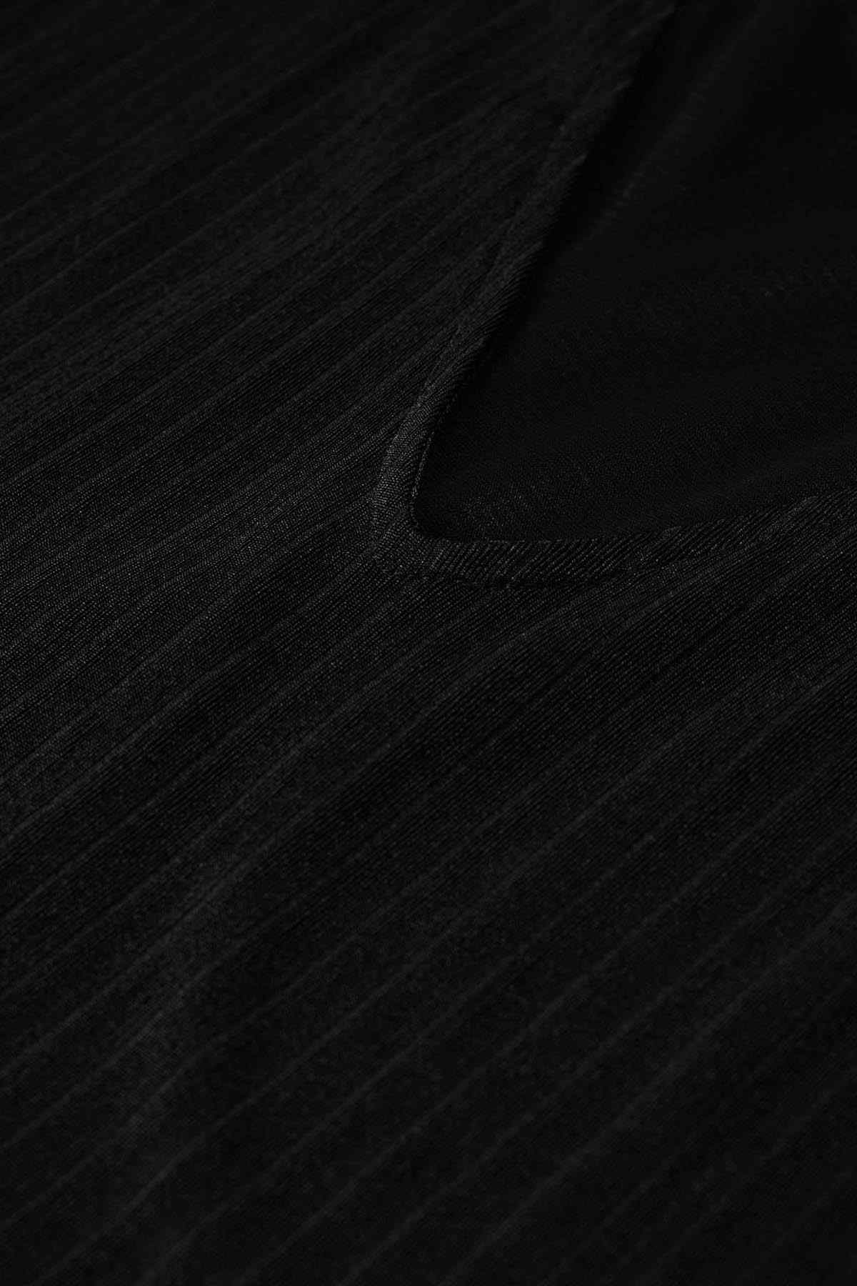 Close-up of black fabric with subtle vertical texture and stitched seam detail
