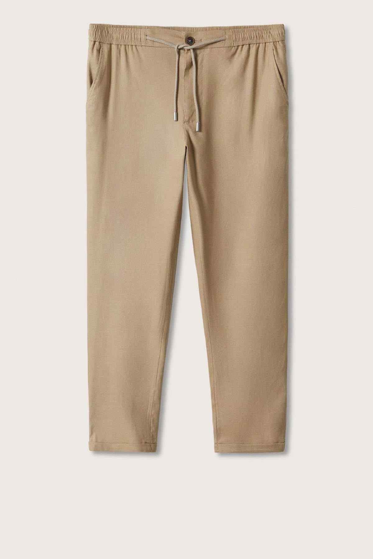 Beige drawstring pants, flat lay with elastic waistband and ankle-length taper