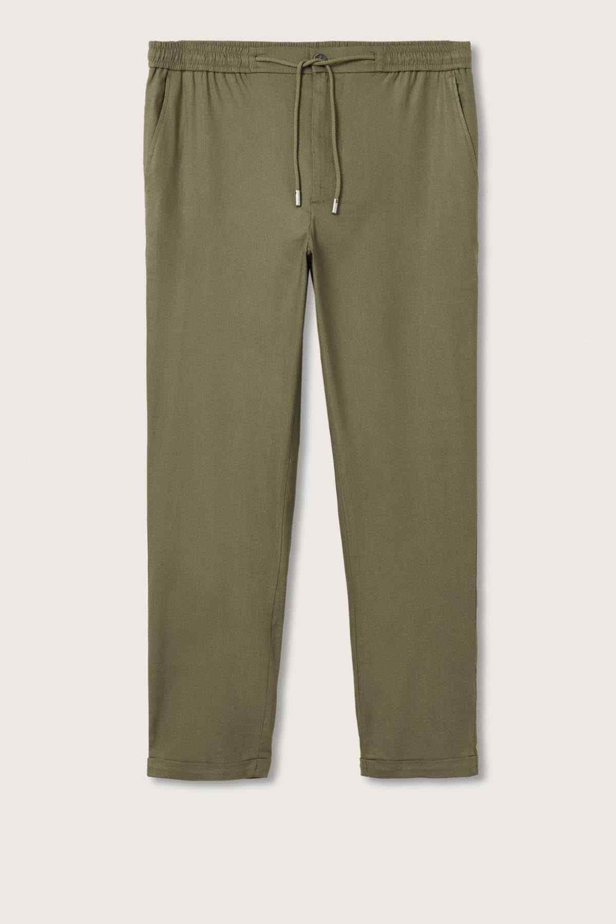 Khaki drawstring trousers on a flat lay, elastic waist and straight legs