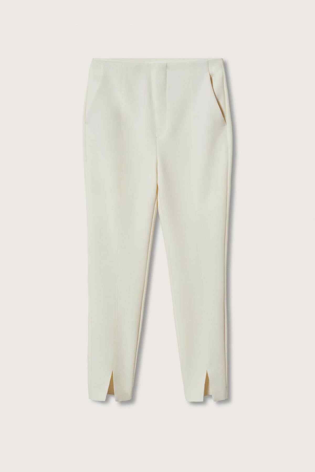 Off-white trousers laid flat with center crease and side slits