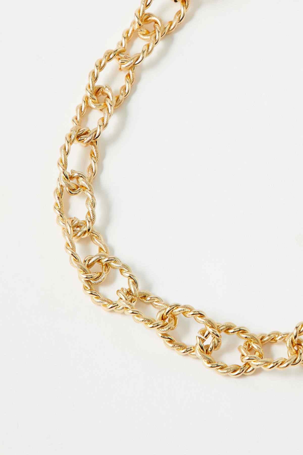 Close-up of gold chunky chain necklace with interlocking links