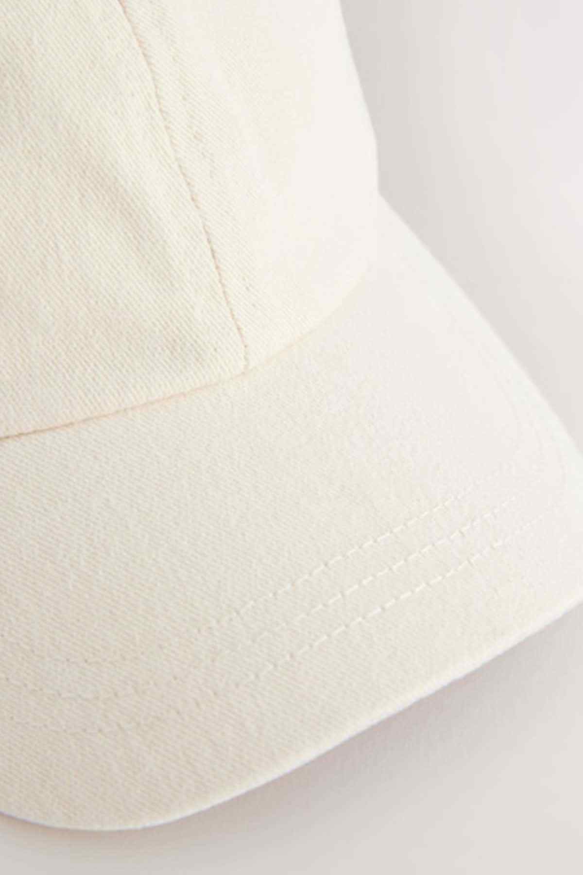 Stone baseball cap brim with visible stitching and seam detail