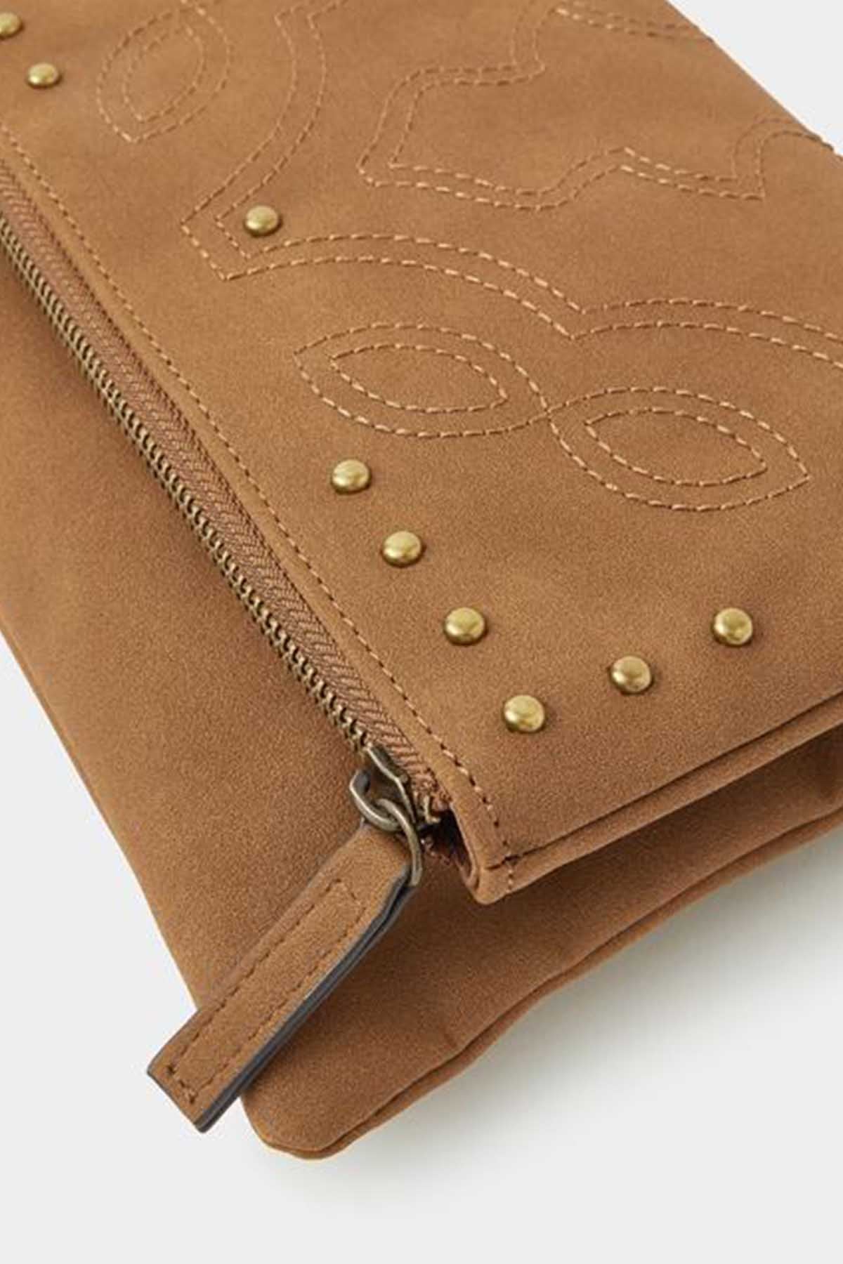 Tan embroidered clutch bag close-up with gold studs and zipper pull