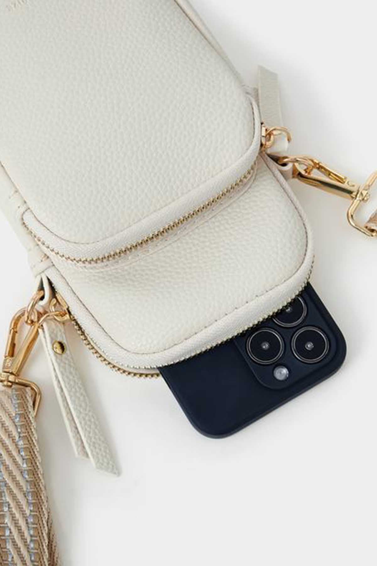 Cream mini crossbody bag close-up with inner smartphone pocket and gold clasp