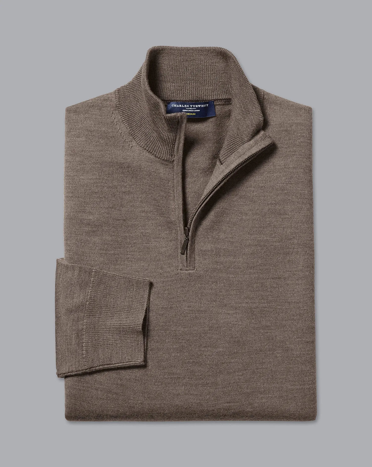 Men's brown quarter-zip sweater folded, mock neck and ribbed cuffs