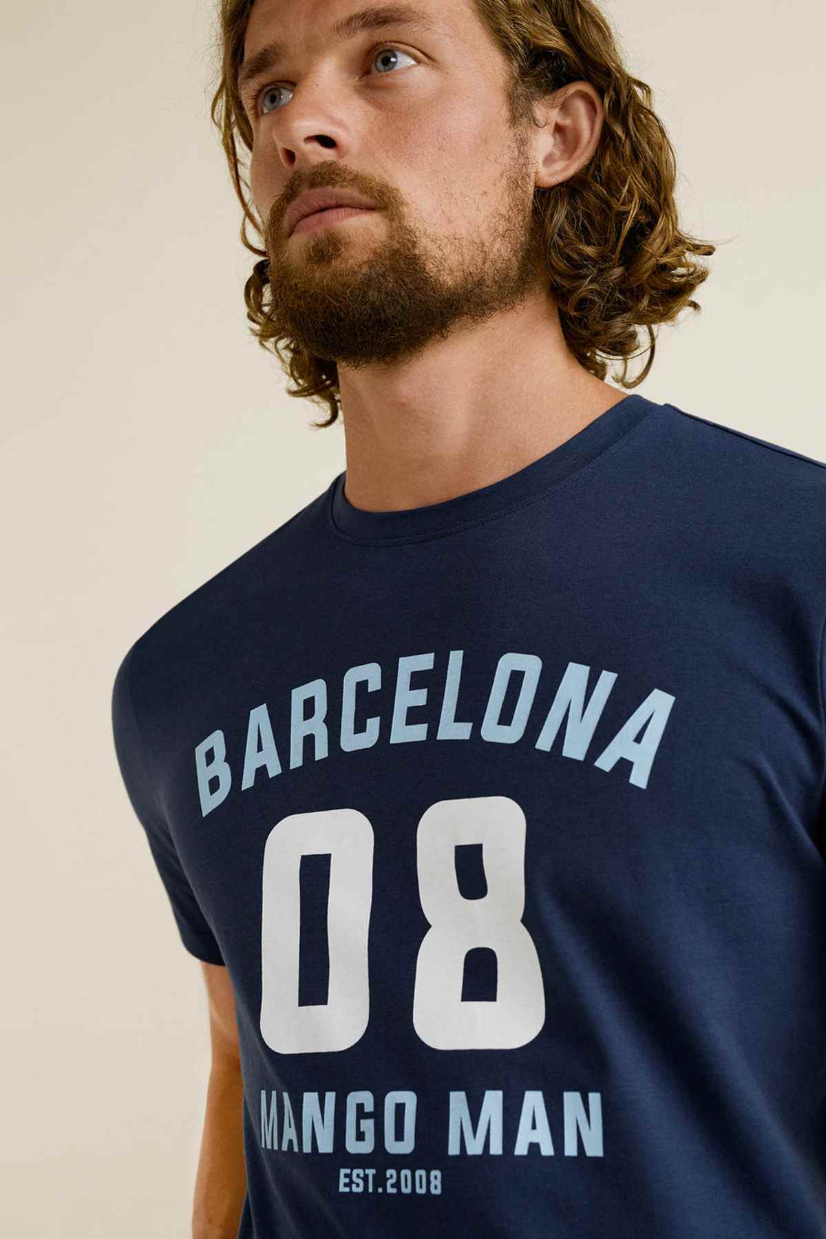 Dark navy Mango T-shirt close-up with 'BARCELONA 08' and 'MANGO MAN' text