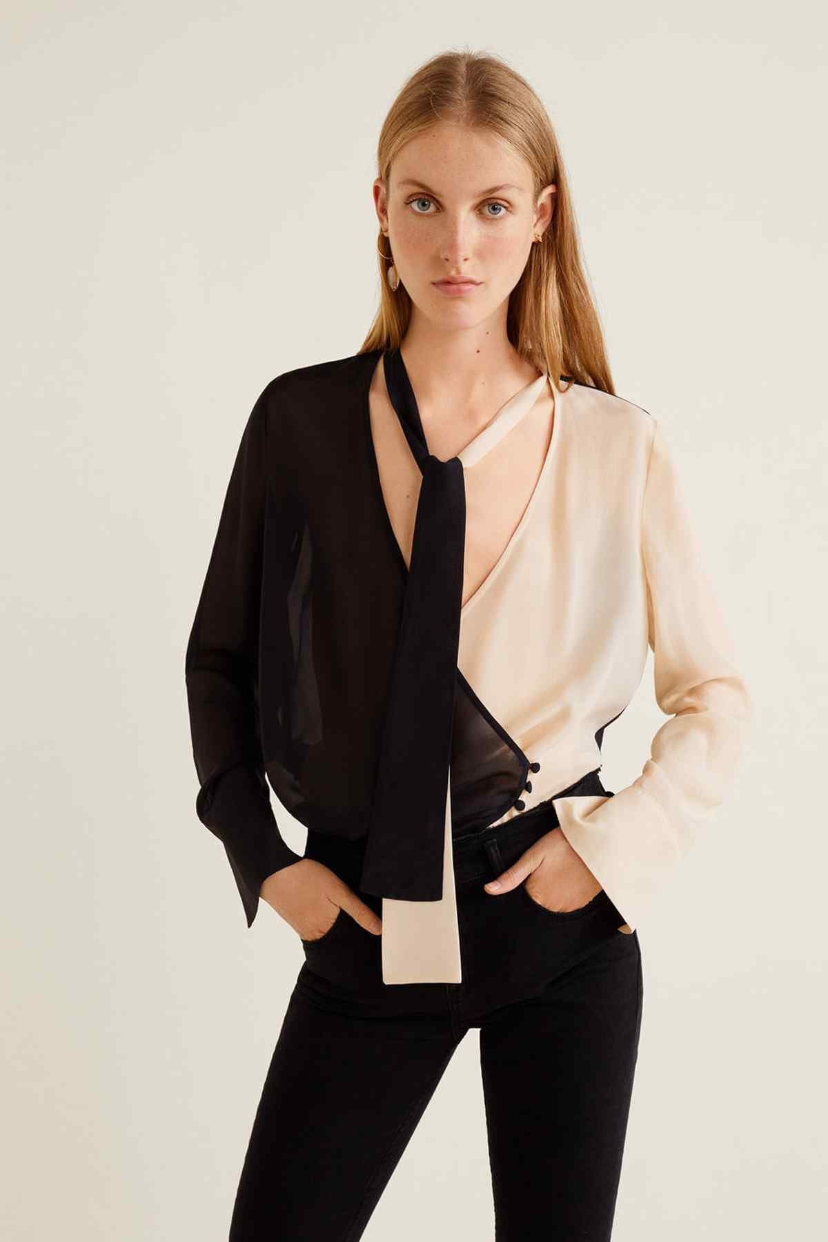 Black denim jeans with fitted straight leg and cuffed cropped hem on model