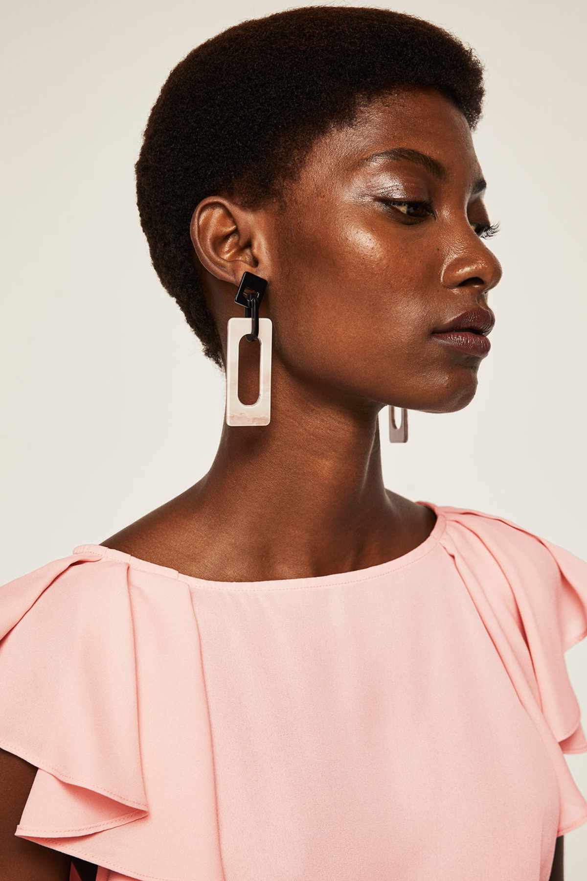 Pink blouse close-up with flutter ruffle sleeve and round neckline