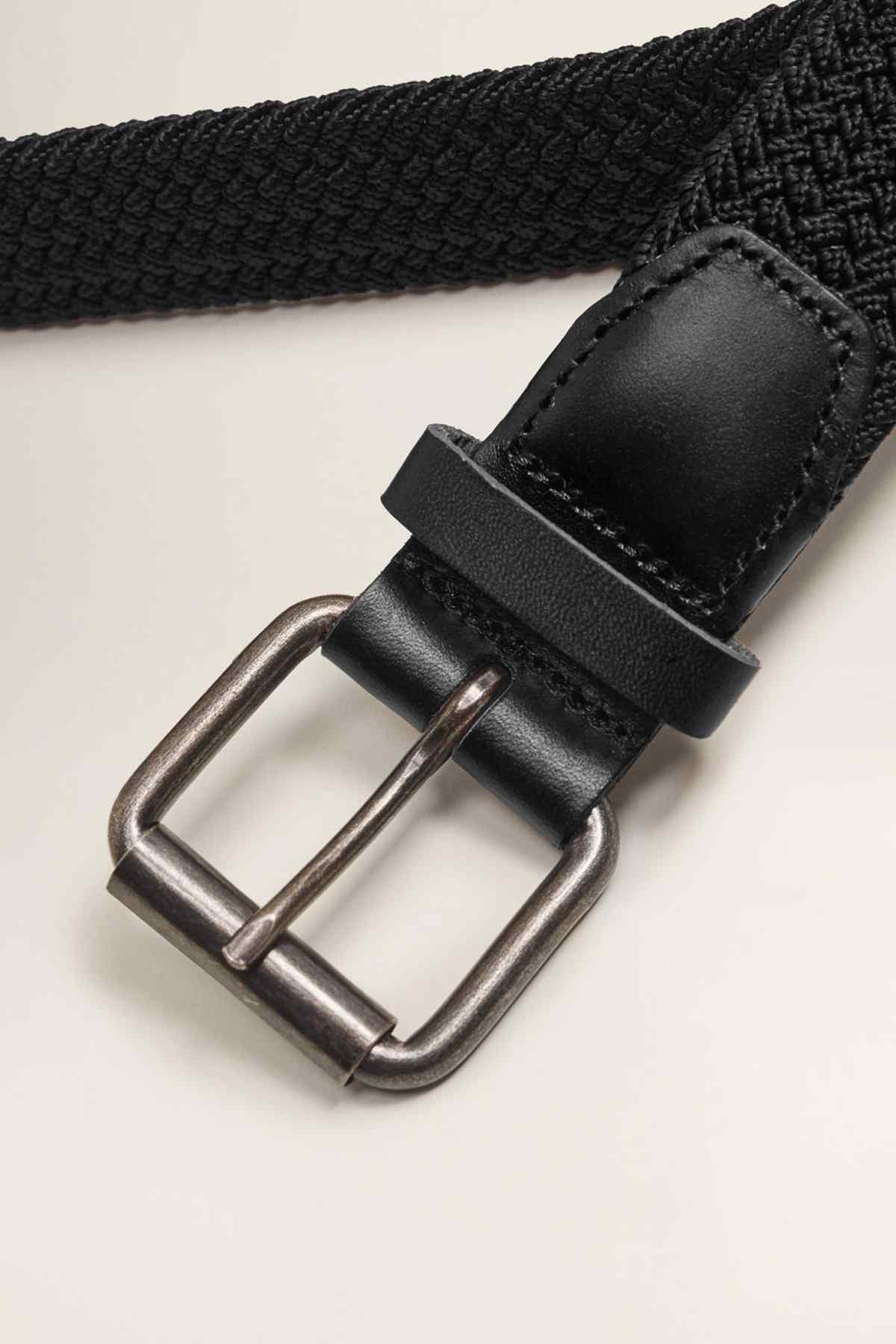 Black woven belt with silver metal buckle and leather keeper