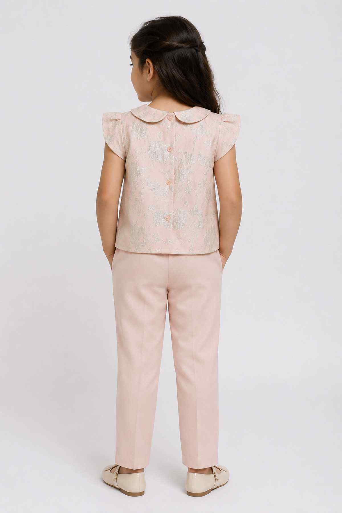 Back view: pink patterned short-sleeve top with Peter Pan collar and pink pants