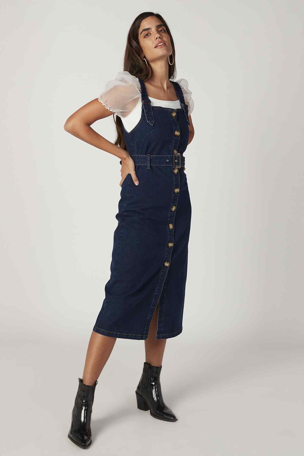 Blue denim pinafore midi dress with adjustable straps and center front slit