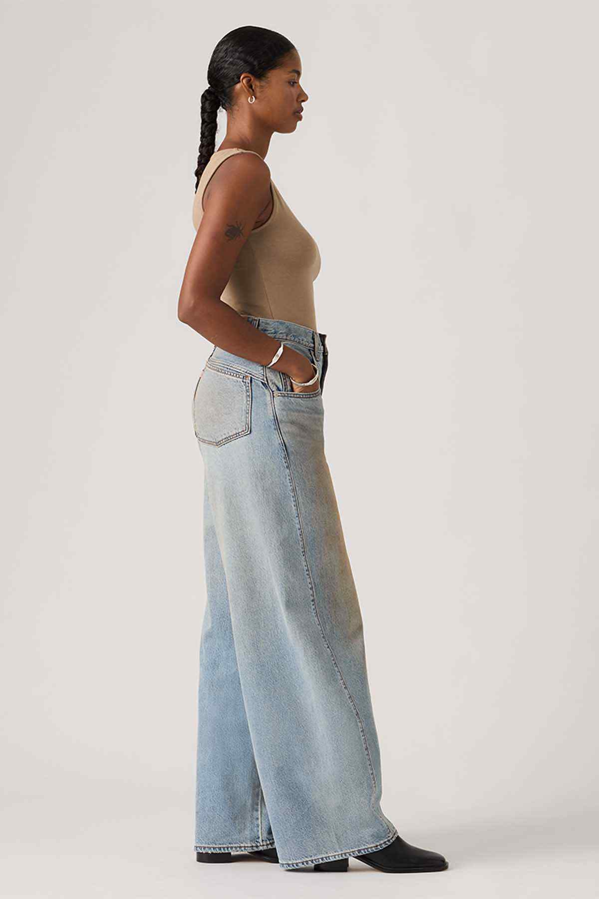 Levi's light-wash wide-leg jeans shown from the side with button closure