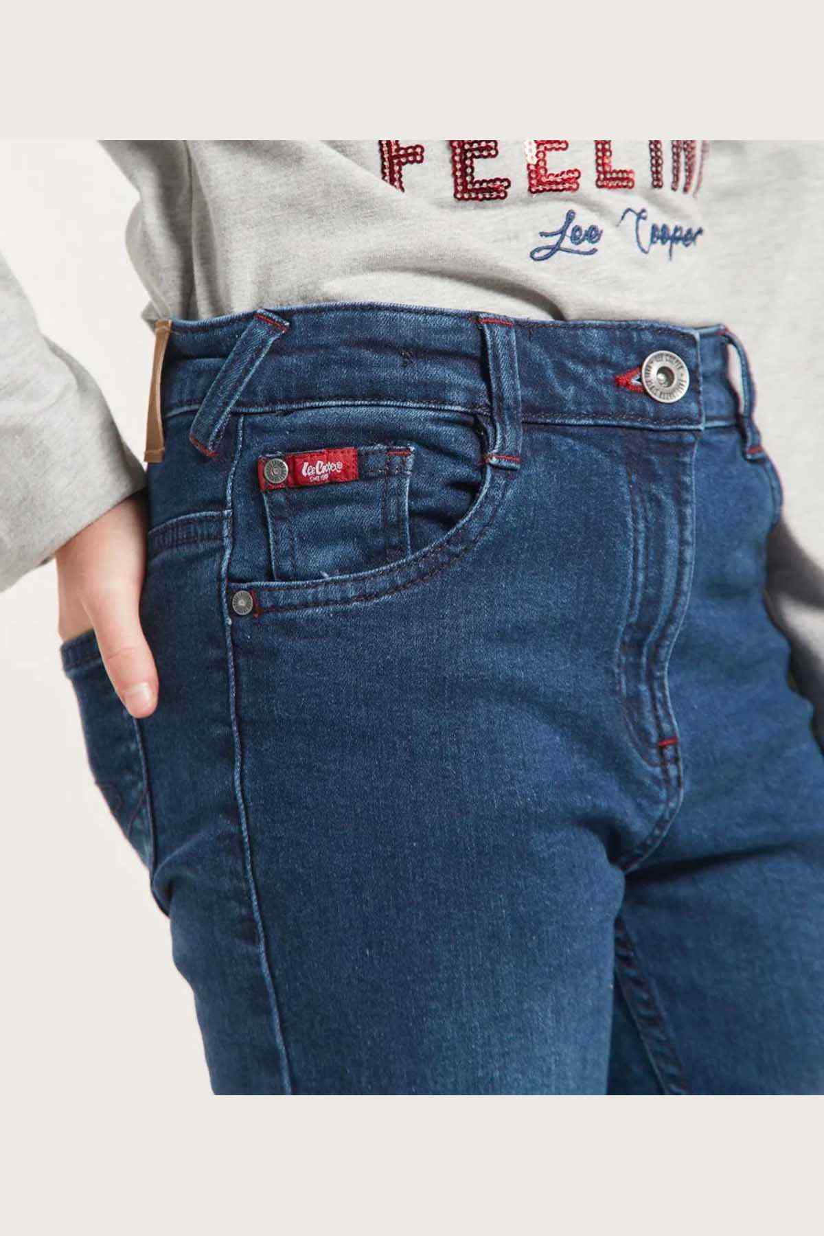 Kids blue denim jeans close-up of waistband button and coin pocket patch